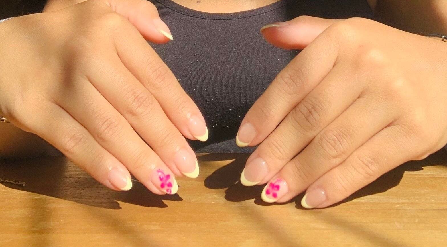 Perfectly manicured hands with floral designs at Ash Beauty Collective, Cape Town, Western Cape, ZA.