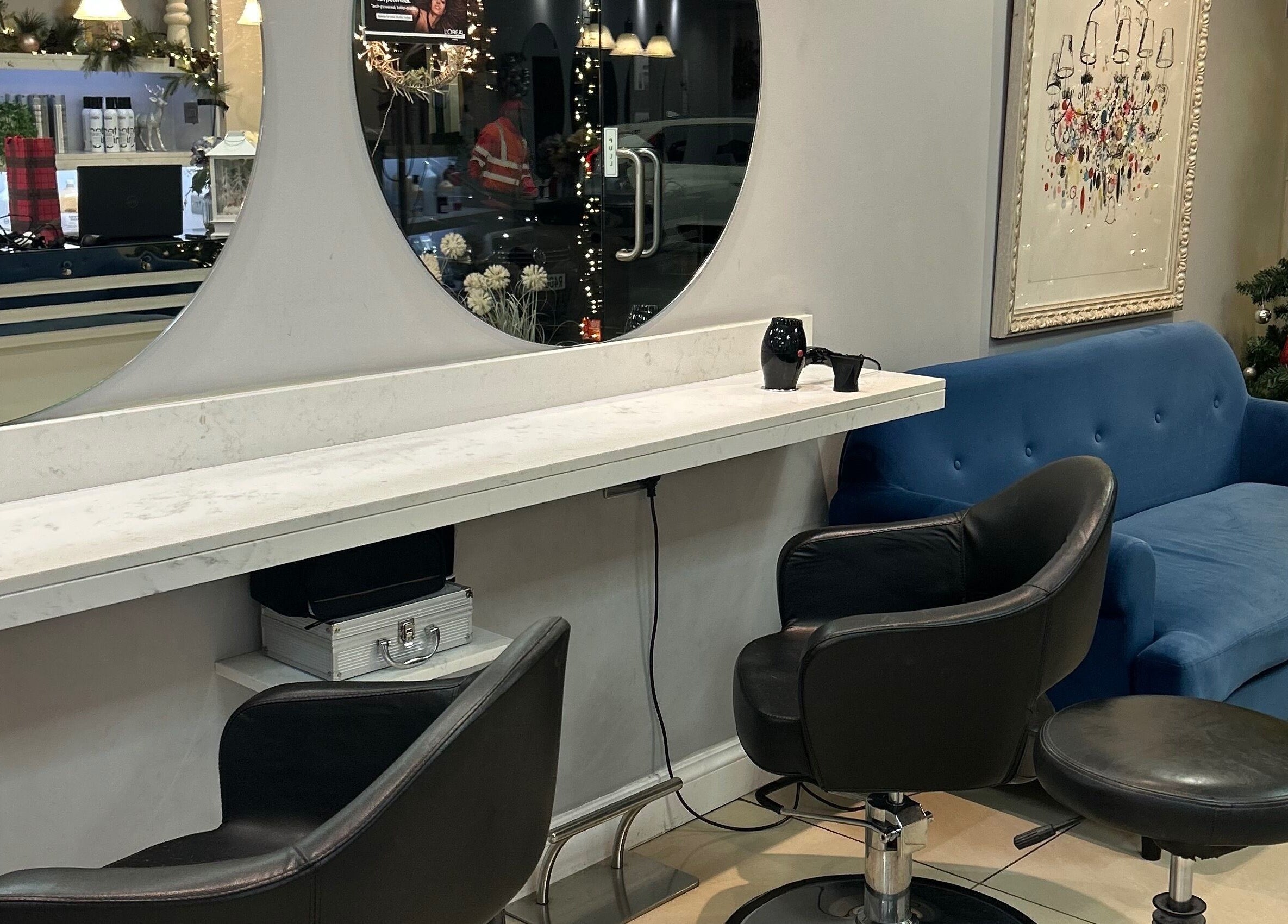 PGeorgiou - Hairdresser's stylish interior with blue sofa and holiday decor, Worcester Park, England, GB.