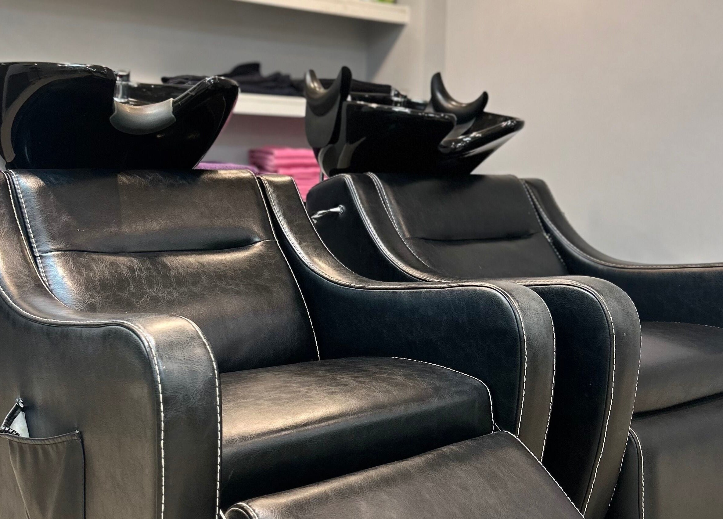 Comfortable leather salon chairs at PGeorgiou - Hairdresser, Worcester Park, England, GB.