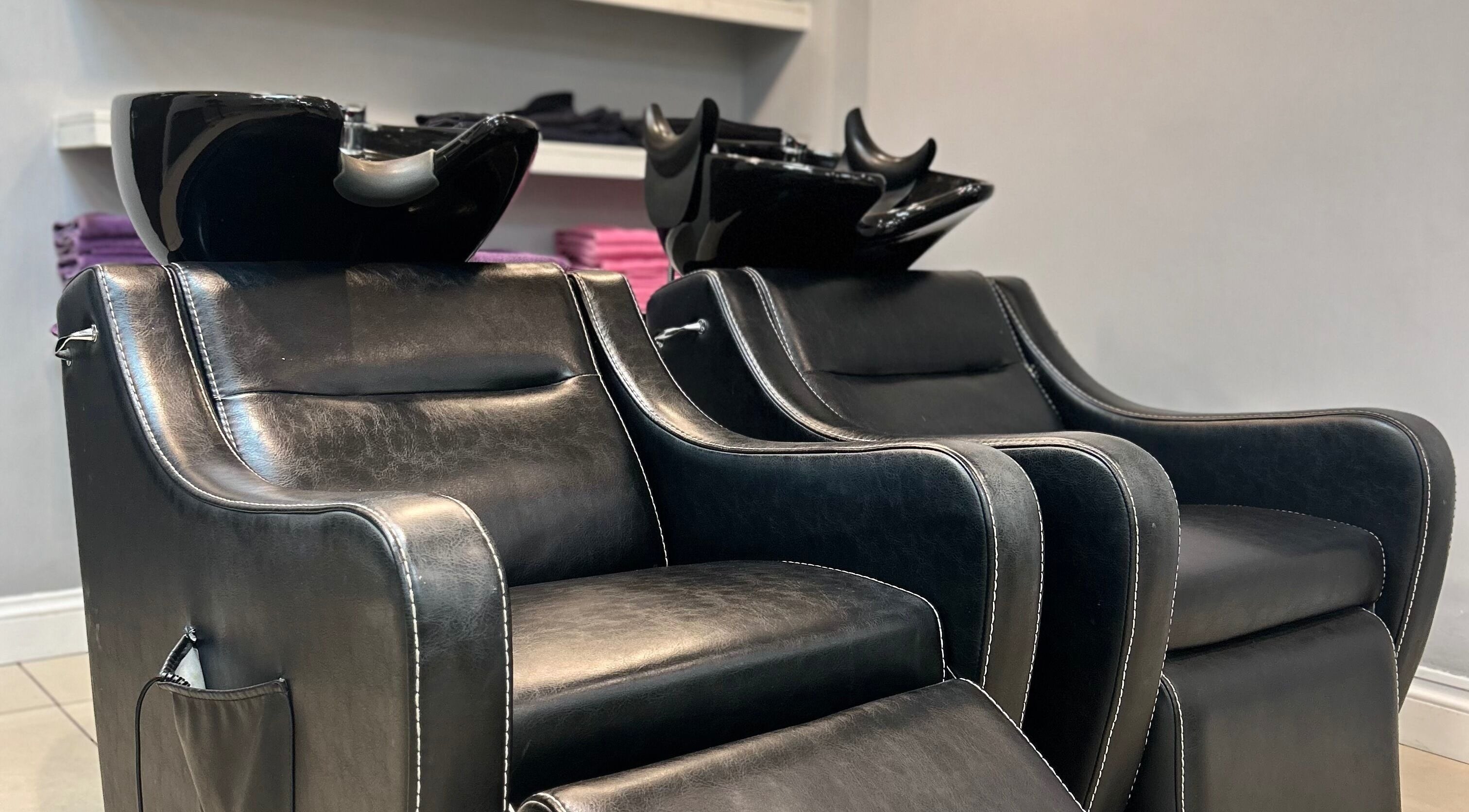 Comfortable leather salon chairs at PGeorgiou - Hairdresser, Worcester Park, England, GB.