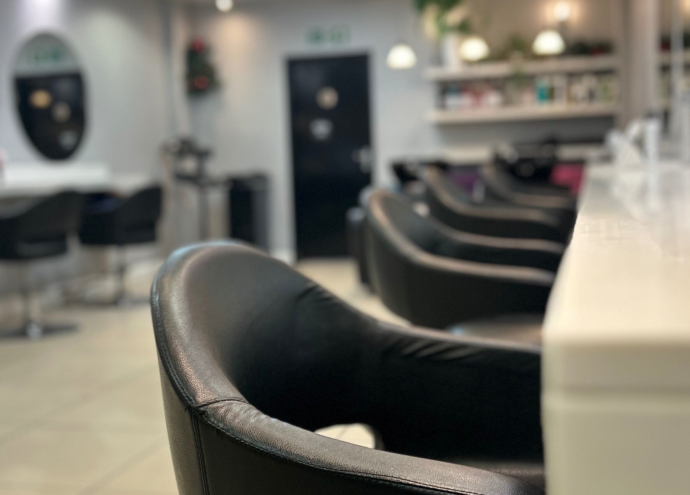 Elegant interior of PGeorgiou - Hairdresser in Worcester Park, England, GB featuring modern salon chairs.
