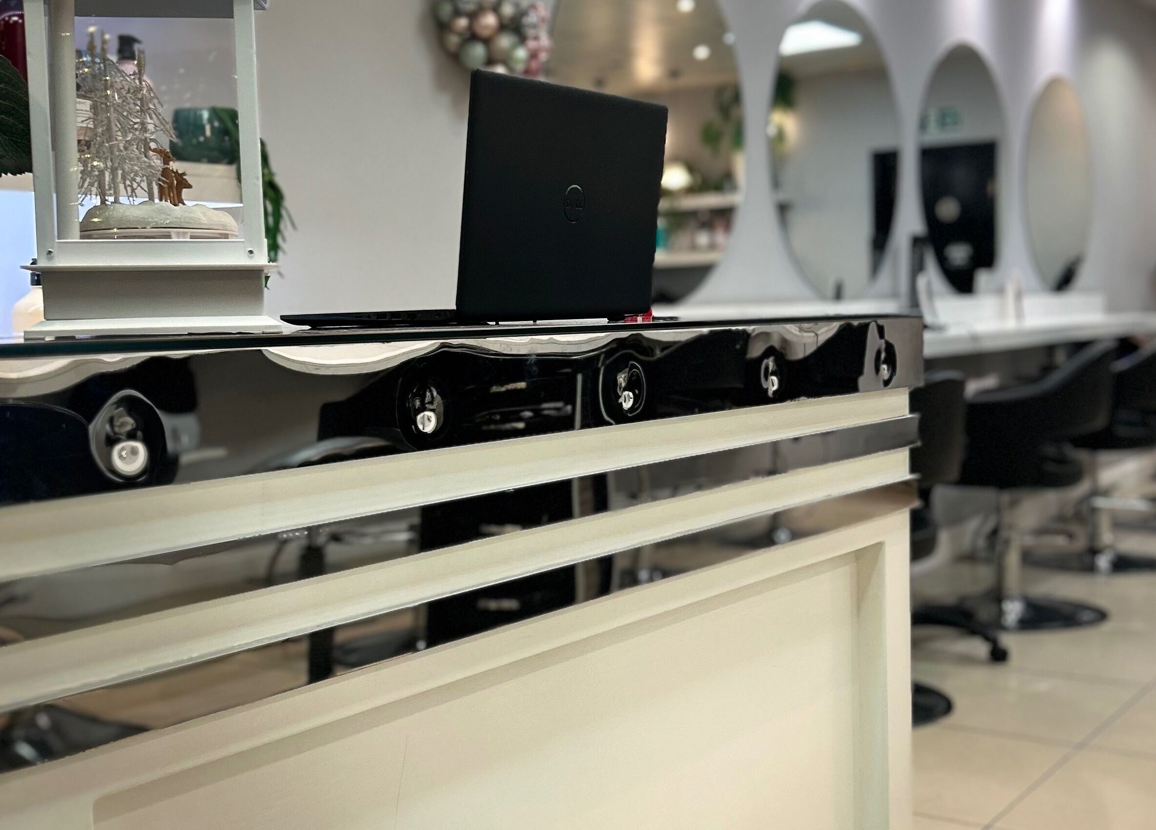 Elegant reception at PGeorgiou - Hairdresser, Worcester Park, England, GB showcasing sleek decor and modern chairs.