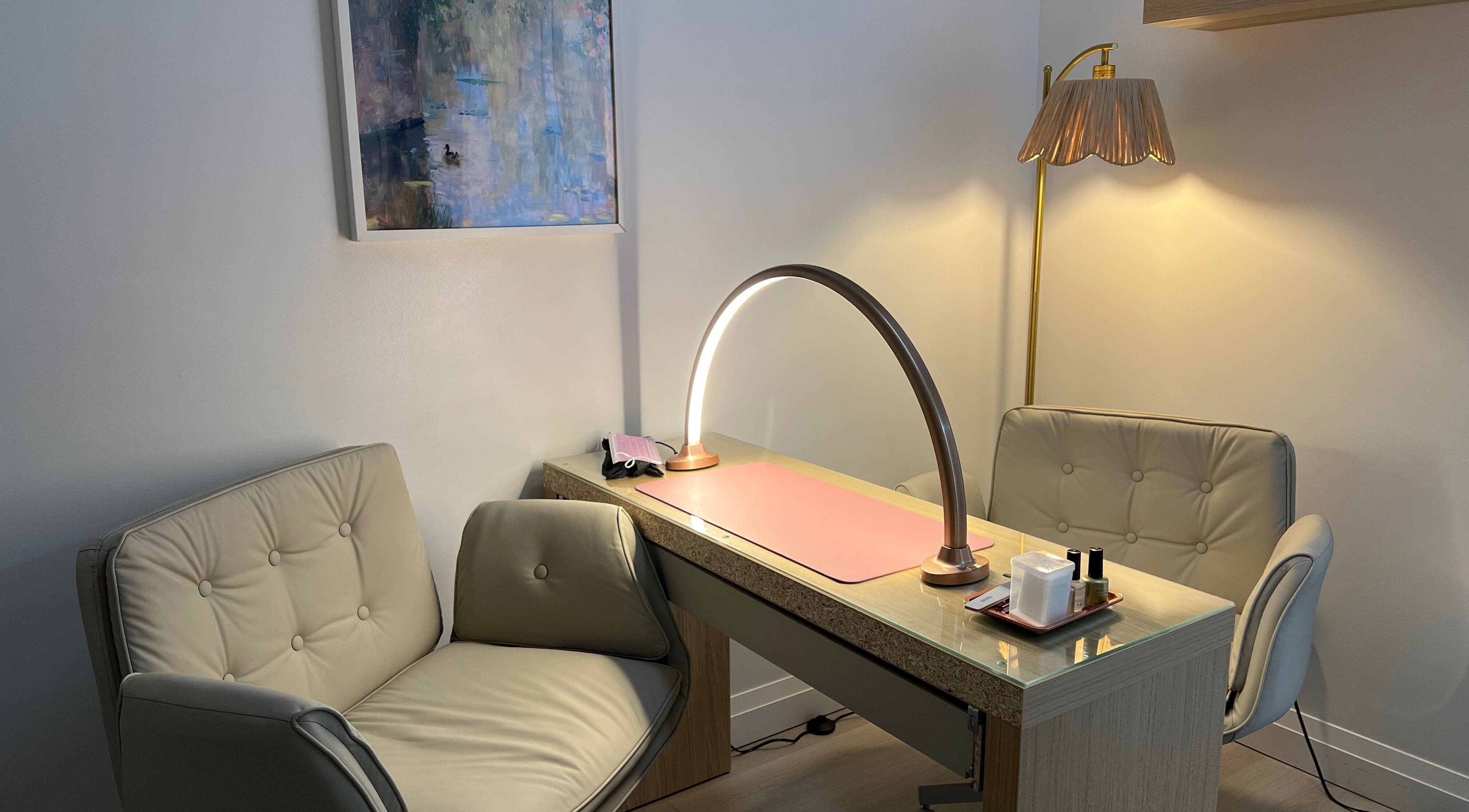 Elegant nail service area at The Glossy Garden, Hamilton, Ontario, CA with cozy chairs and modern lighting.