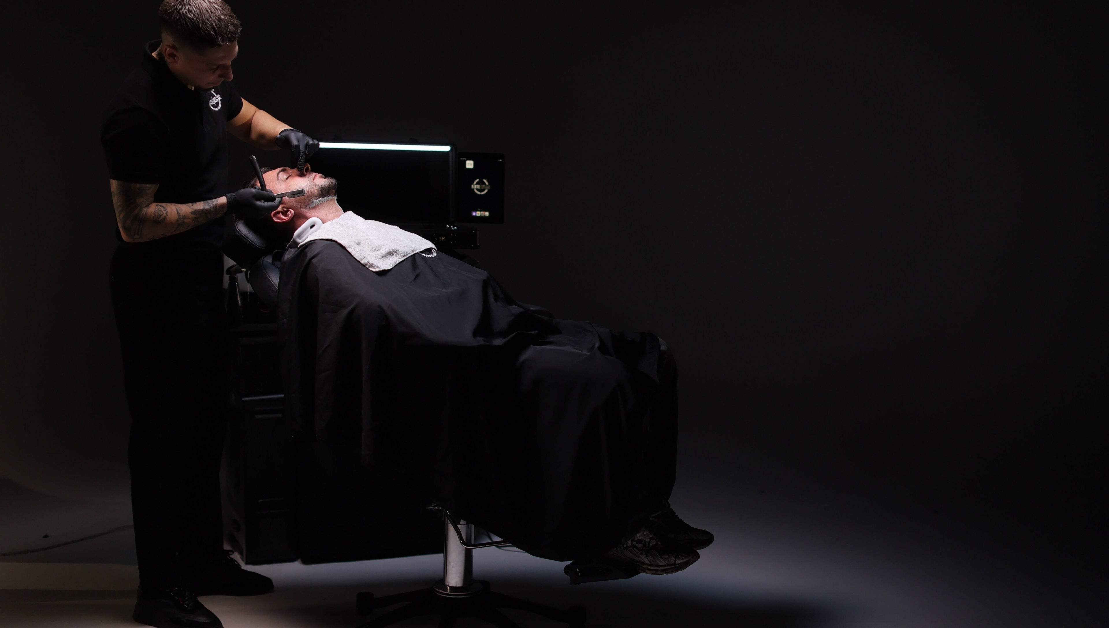 Barber providing a premium shave at Elite Home Private Barber in Dubai, Dubai, AE.