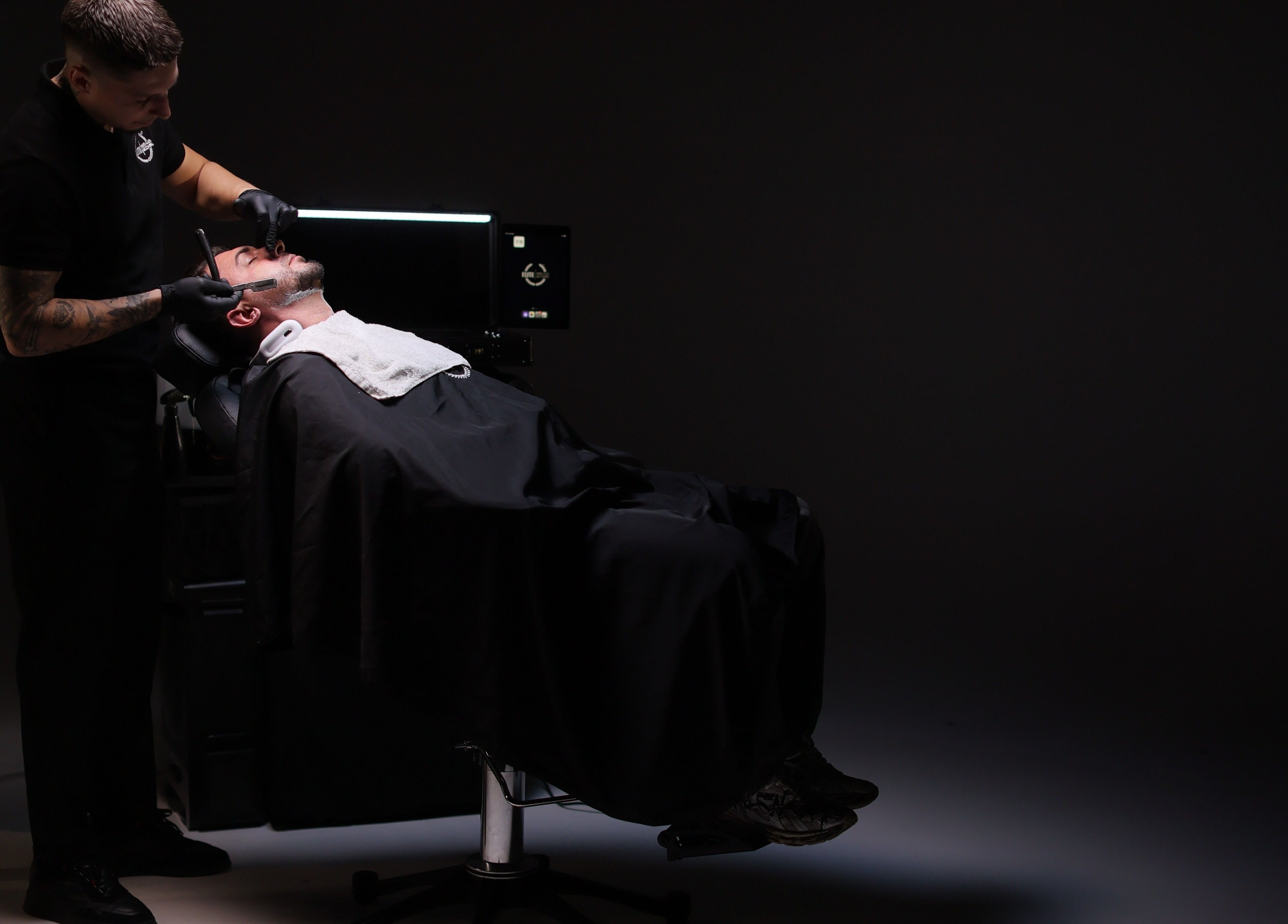 Barber providing a premium shave at Elite Home Private Barber in Dubai, Dubai, AE.