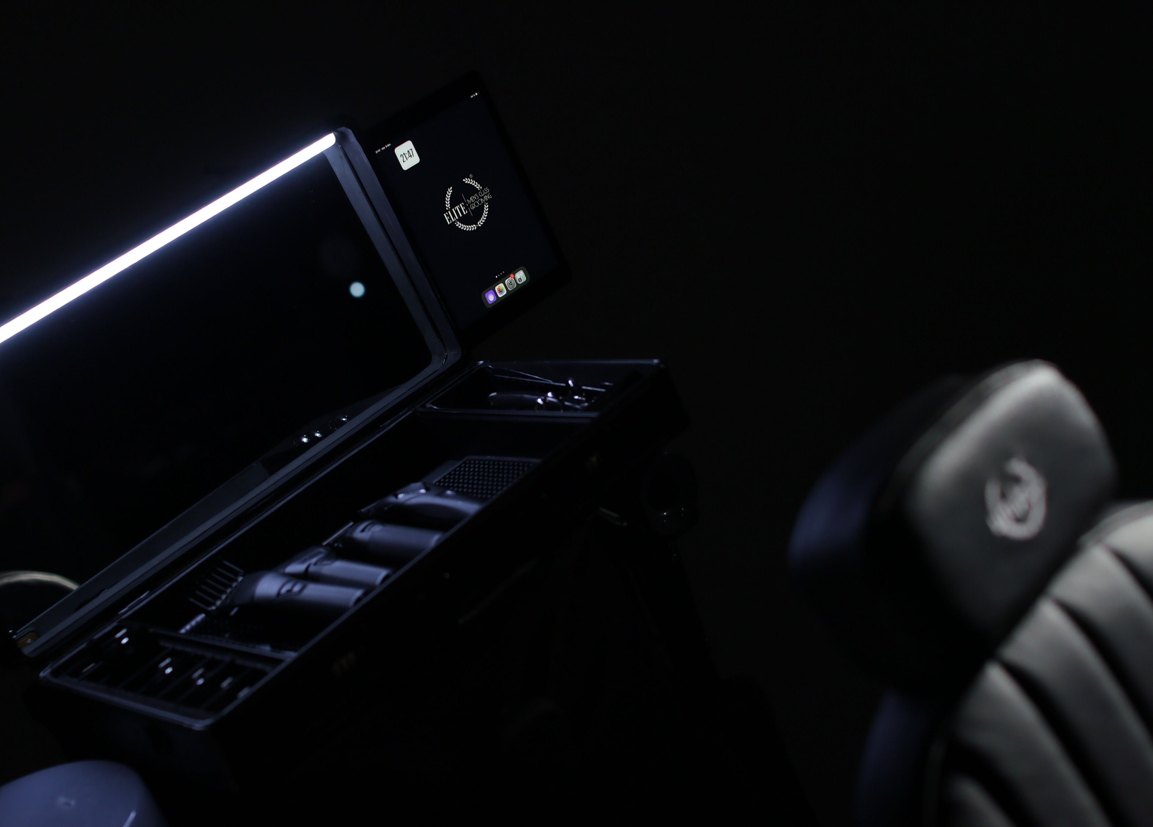 Sleek barber station at Elite Home Private Barber, Dubai, Dubai, AE, featuring illuminated mirror and tools.