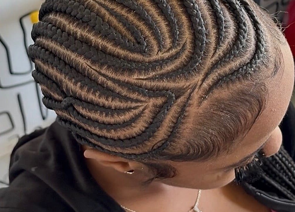 Intricate braid hairstyle at Braids O’clock Oasis Parlour, Accra, Greater Accra Region, GH, showcasing expert skill.