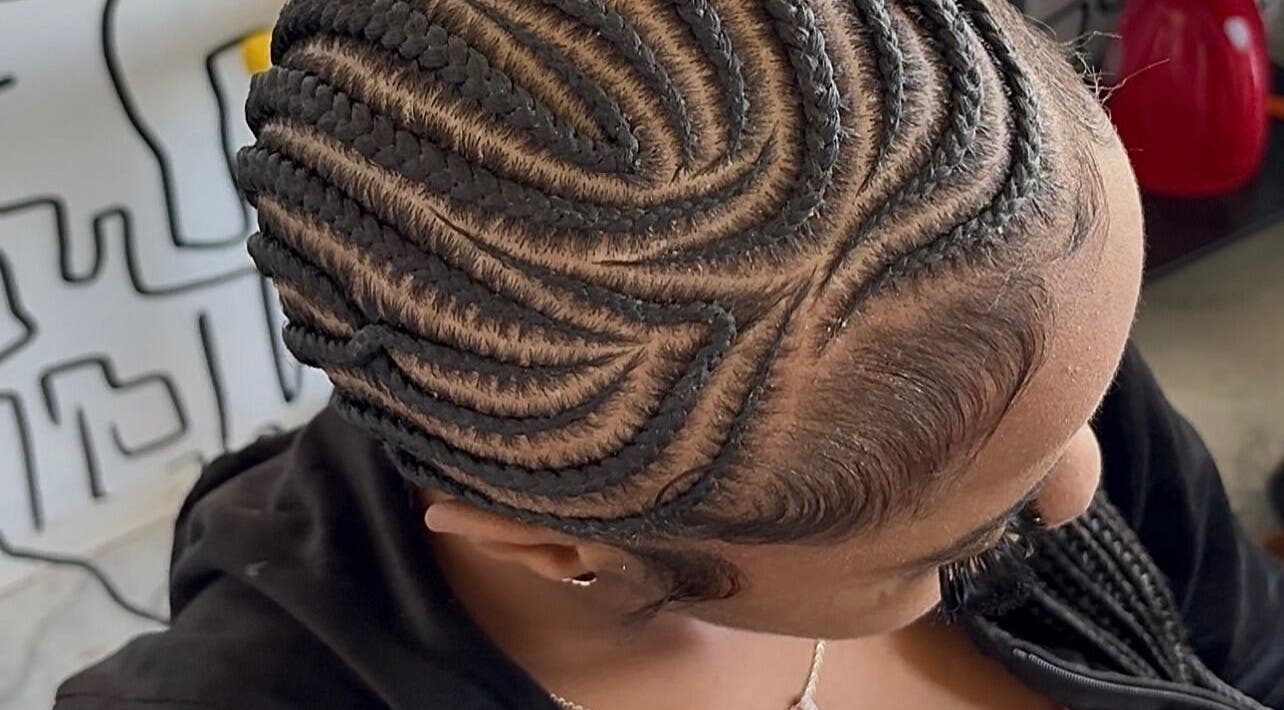 Intricate braid hairstyle at Braids O’clock Oasis Parlour, Accra, Greater Accra Region, GH, showcasing expert skill.