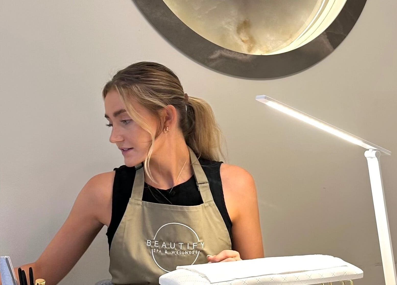 A nail technician at Nails By Bel, Clayton-le-woods, England, GB, working at a tidy station.