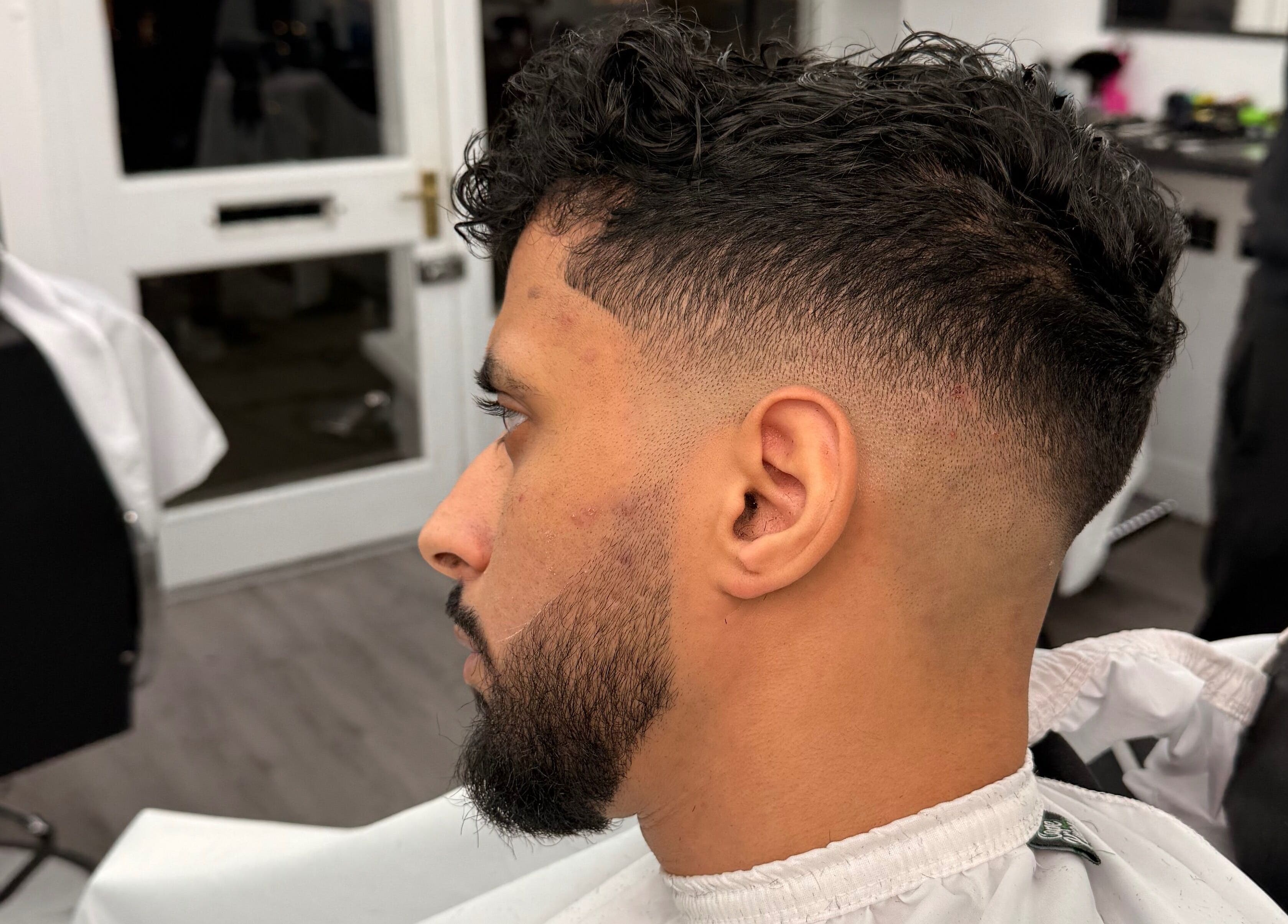Modern fade haircut at Dramz Cutz, Brighton And Hove, England, GB. Perfect blend of style and precision.