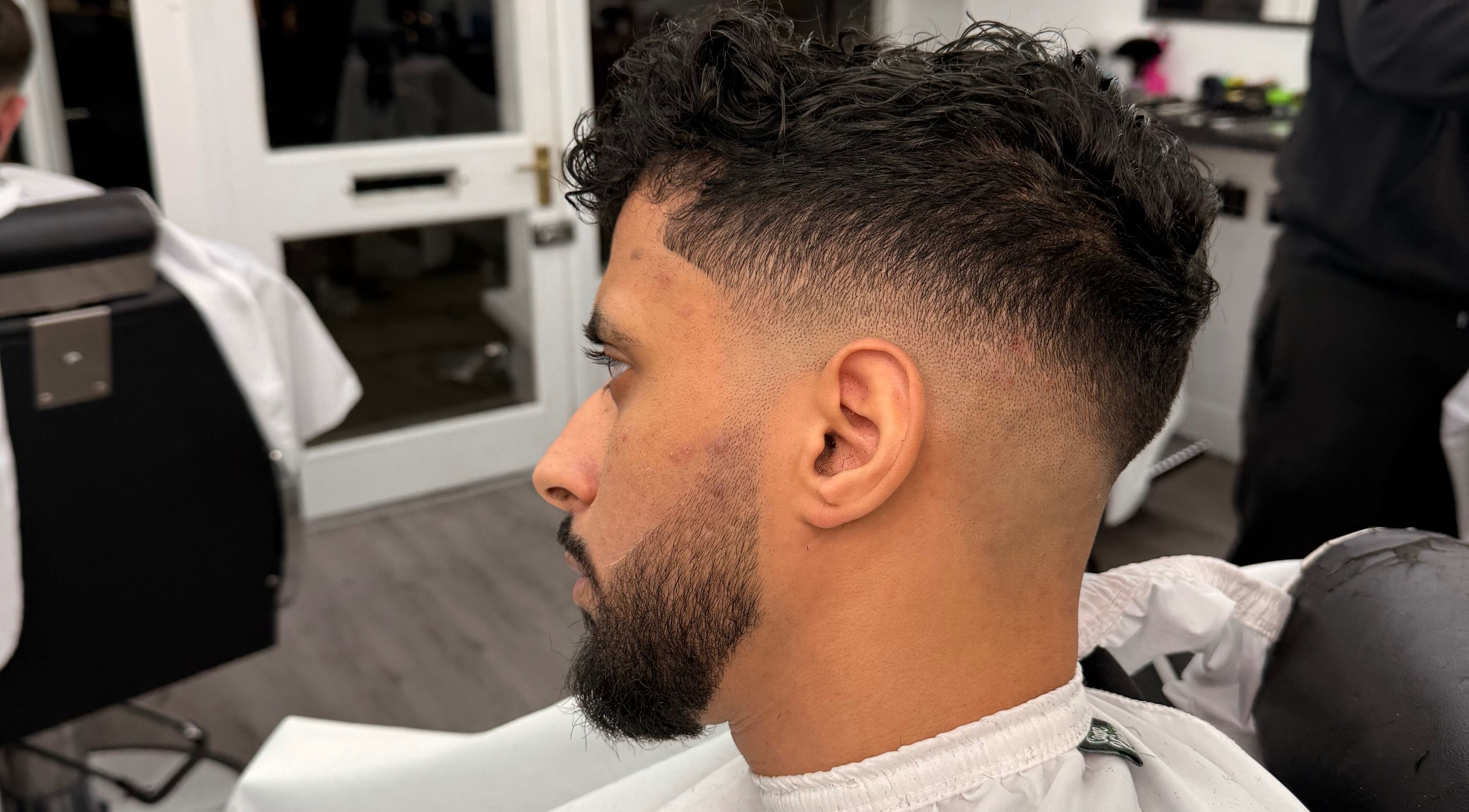 Modern fade haircut at Dramz Cutz, Brighton And Hove, England, GB. Perfect blend of style and precision.