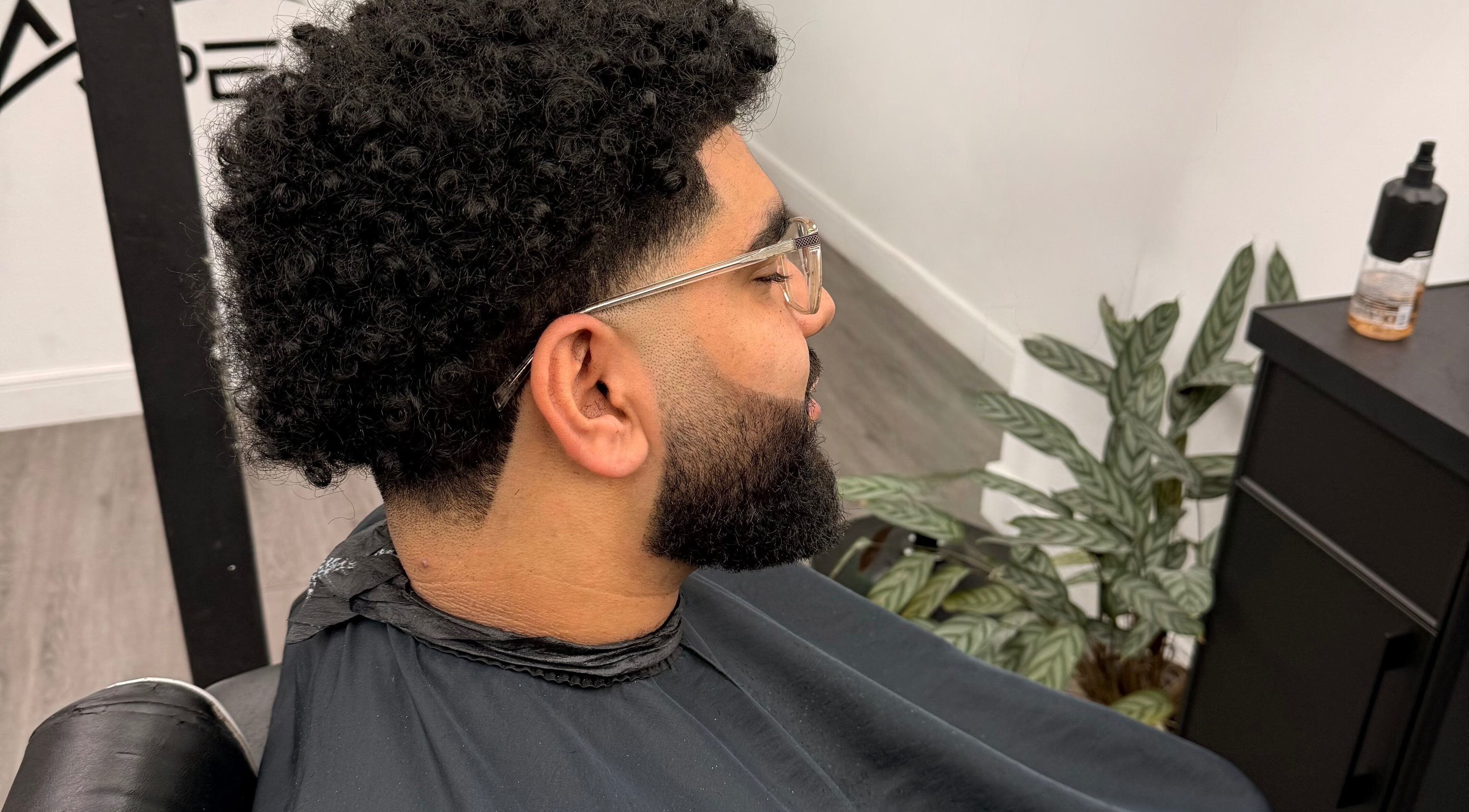 Man with a fresh curly haircut at Dramz Cutz in Brighton And Hove, England, GB.