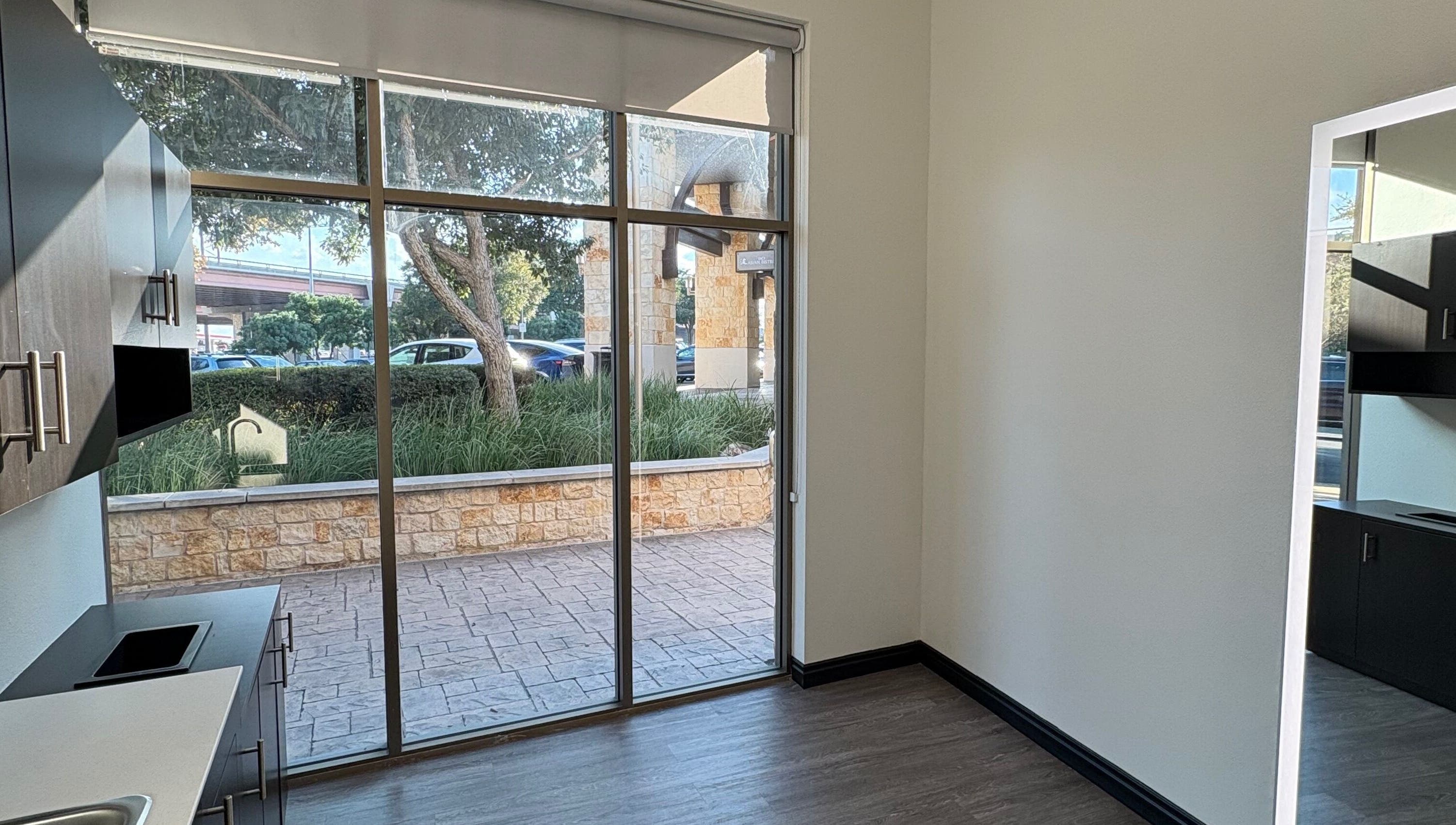 Modern interior view of a tranquil room at Mane Fate Salon, Round Rock, Texas, US, featuring large windows.