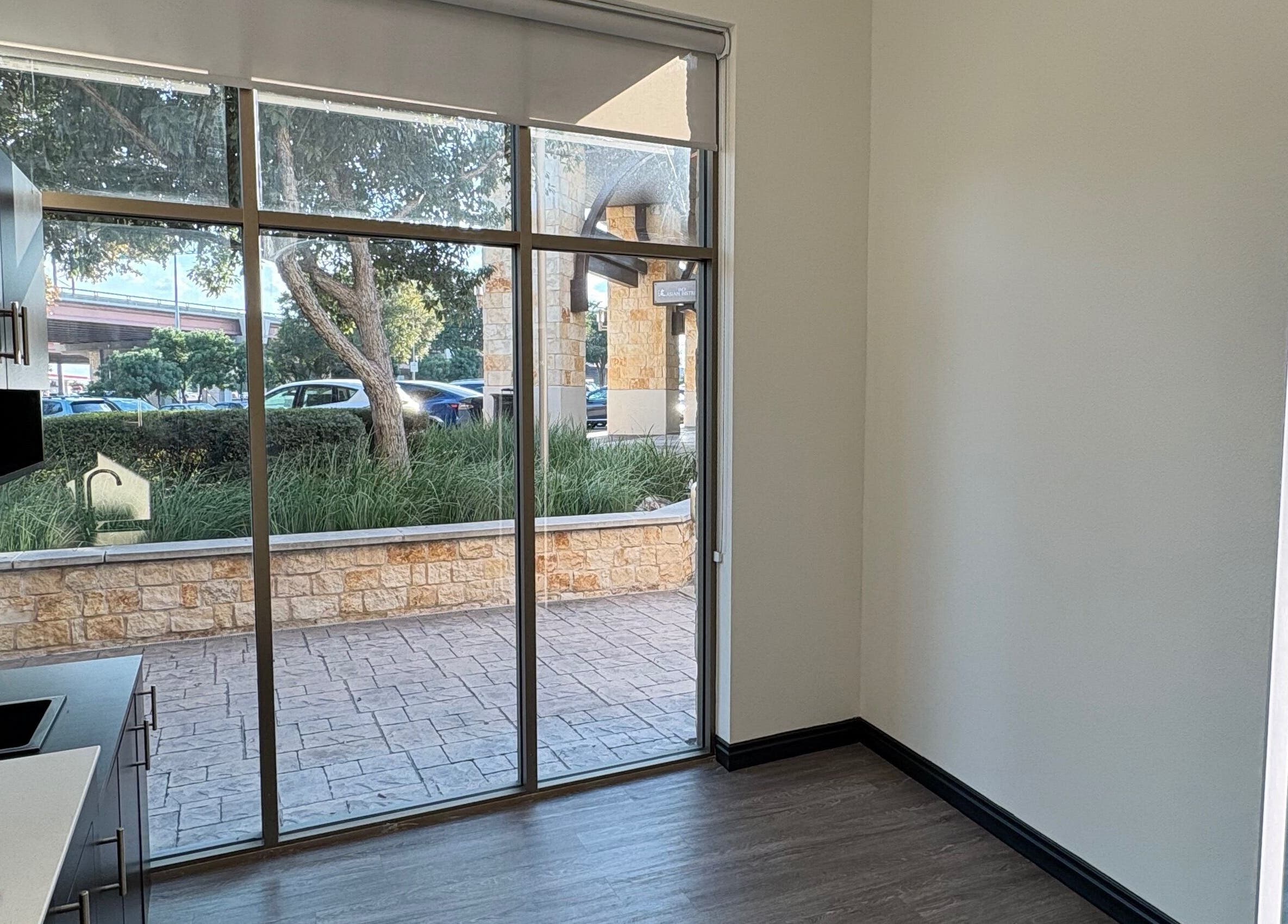 Modern interior view of a tranquil room at Mane Fate Salon, Round Rock, Texas, US, featuring large windows.