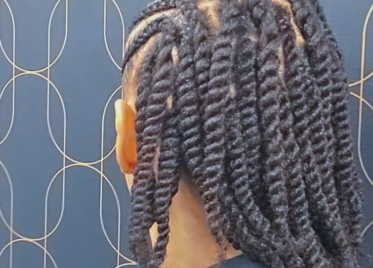 Stylish twisted hairstyle at Catford beauty salon, London, England, GB.