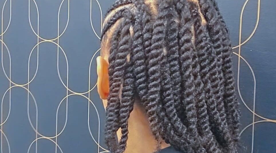 Stylish twisted hairstyle at Catford beauty salon, London, England, GB.
