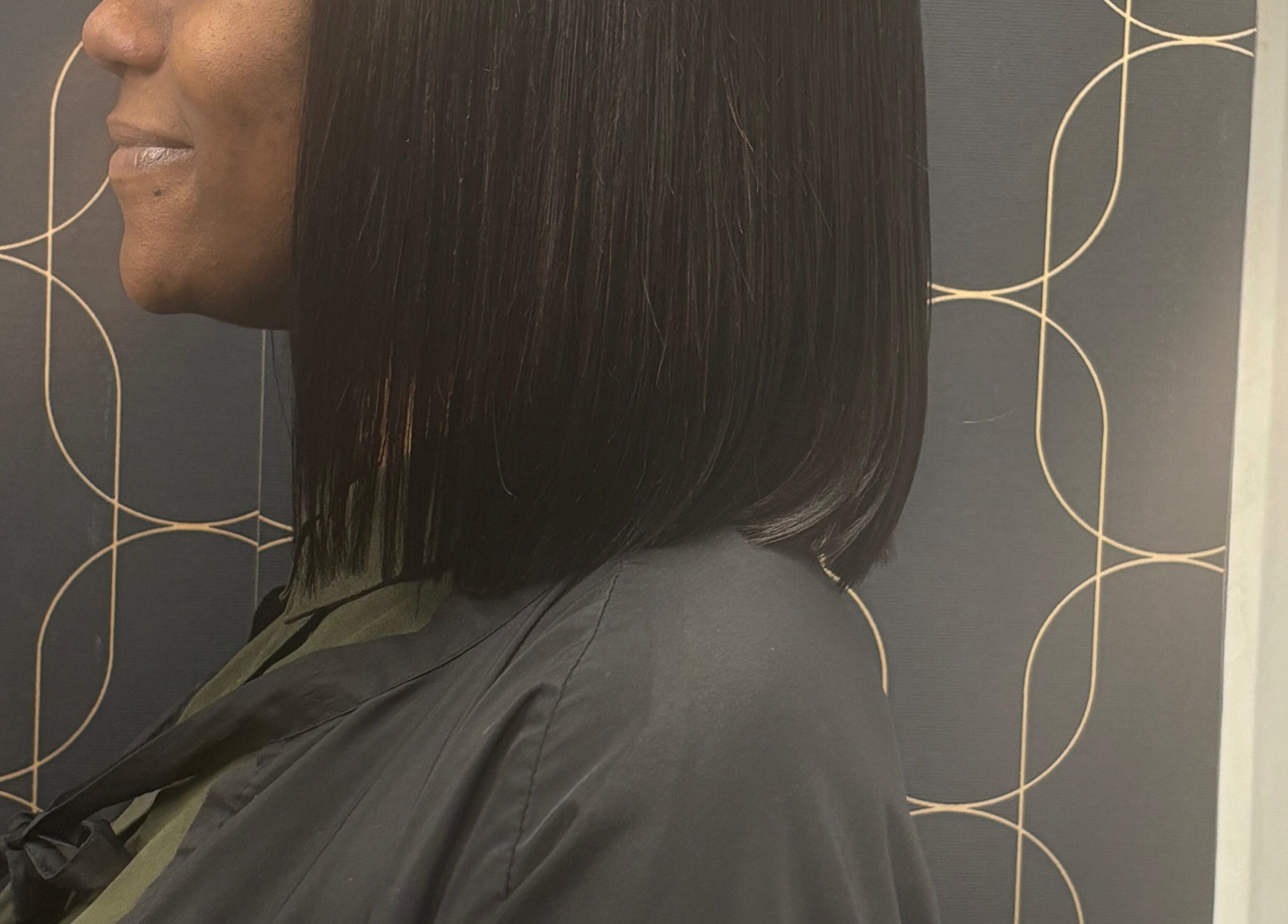 Side view of sleek bob hairstyle at Catford salon, London, England, GB, showcasing chic elegance.