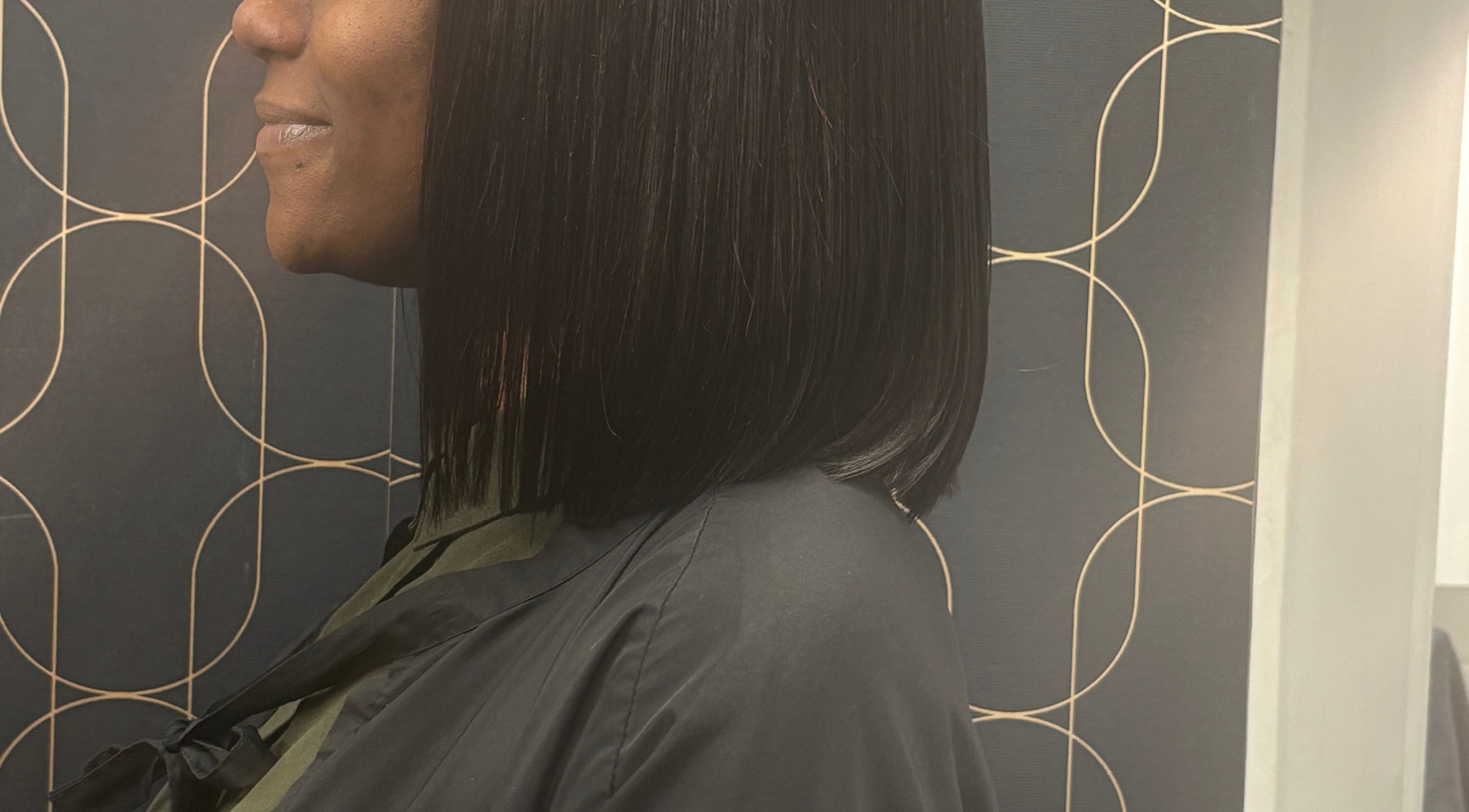 Side view of sleek bob hairstyle at Catford salon, London, England, GB, showcasing chic elegance.