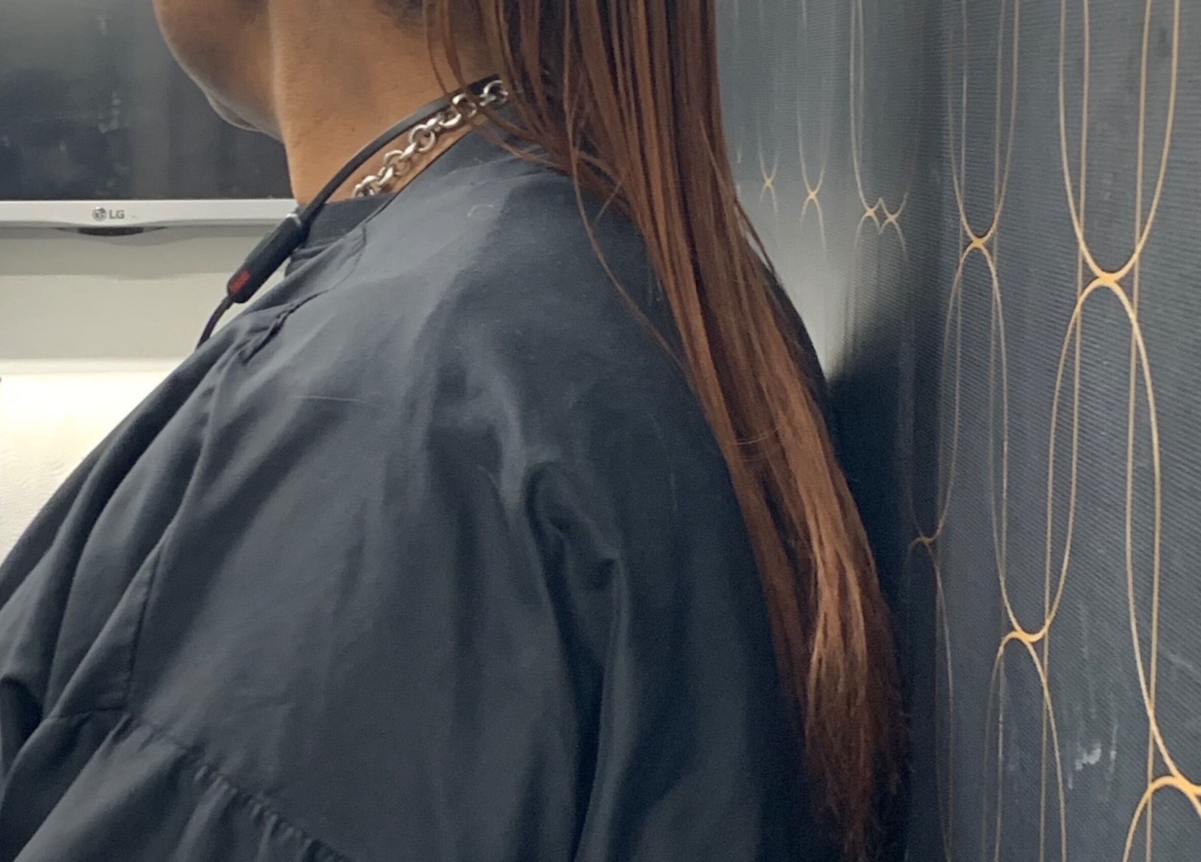 Close-up of sleek long hair styled at Catford salon in London, England, GB, emphasizing luxurious texture.