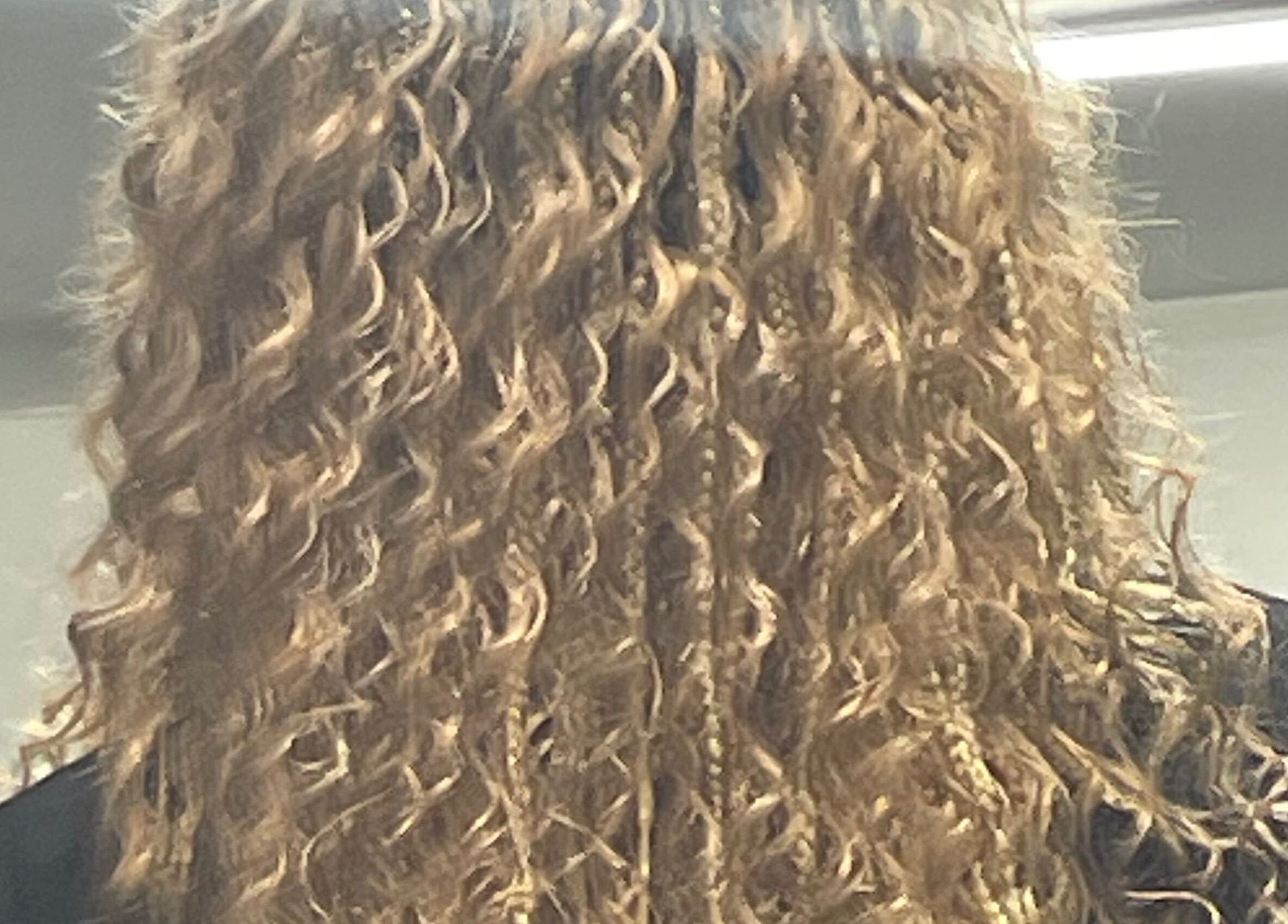 Detailed view of stylish curly hair at Catford salon, London, England, GB.