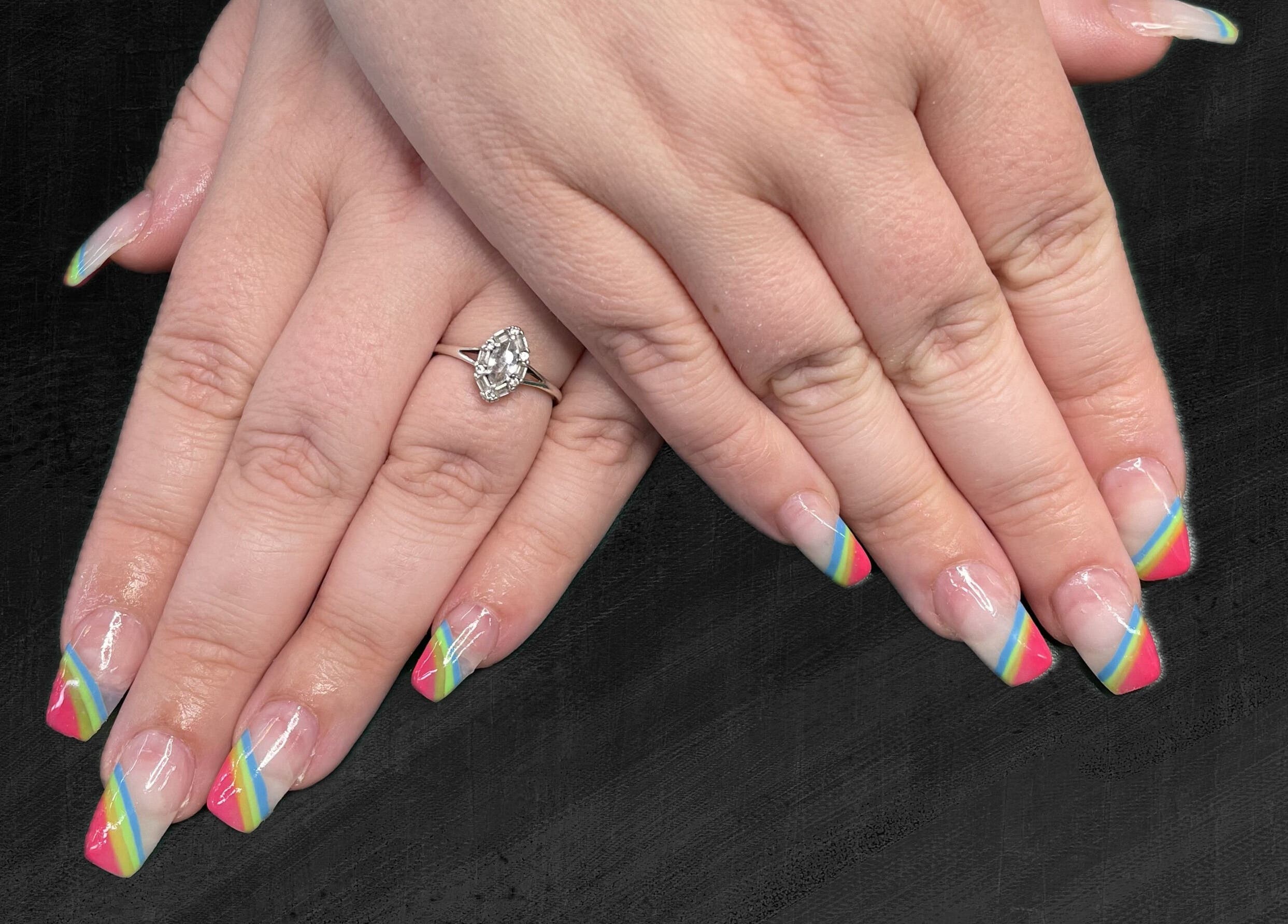 Vibrant rainbow nail design at The Nail Cabin - Muskoka in Huntsville, Ontario, CA. Elegant and trendy manicure.