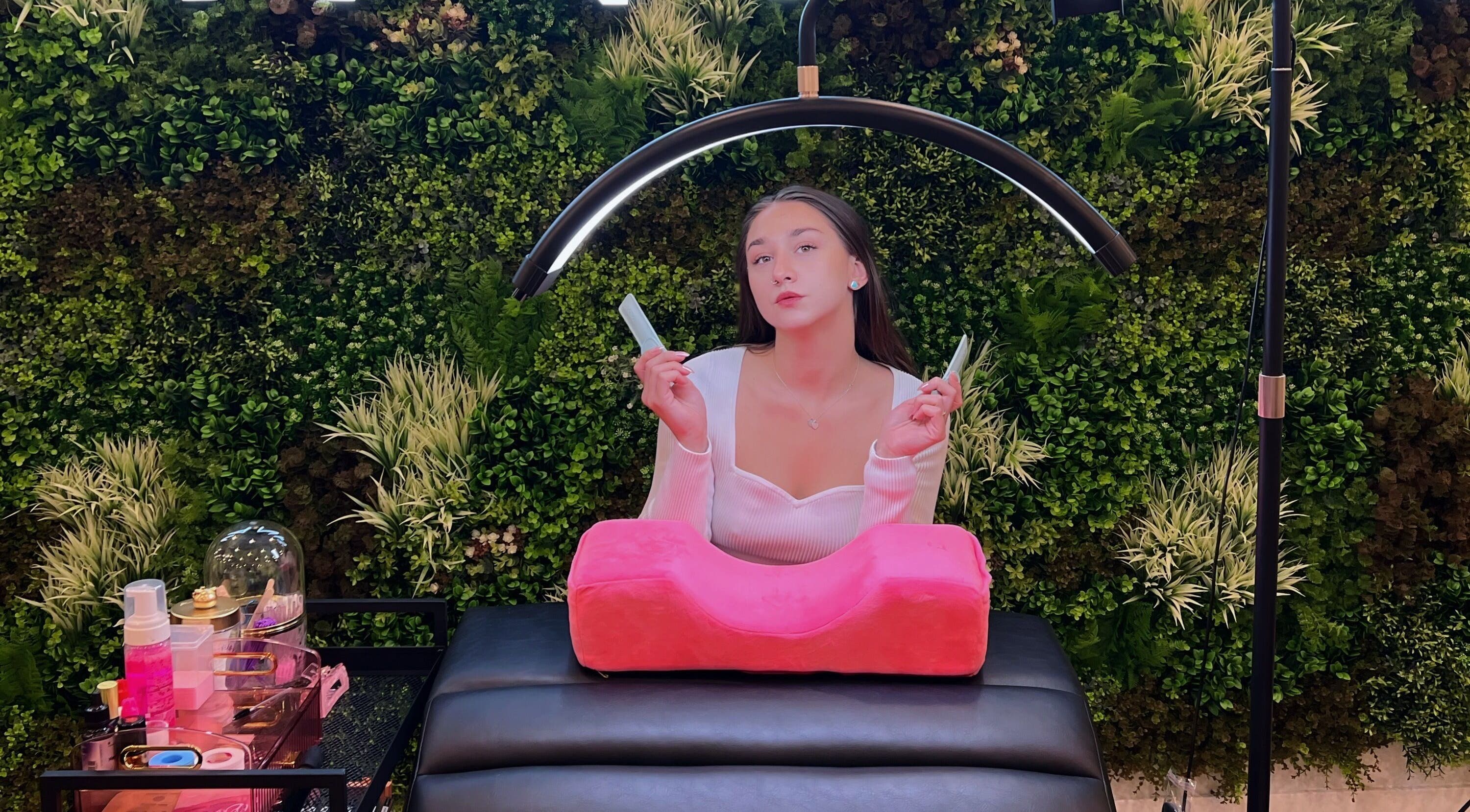 Relaxing lash service at Frances Lash Art, Vancouver, British Columbia, CA, featuring a lush green backdrop.