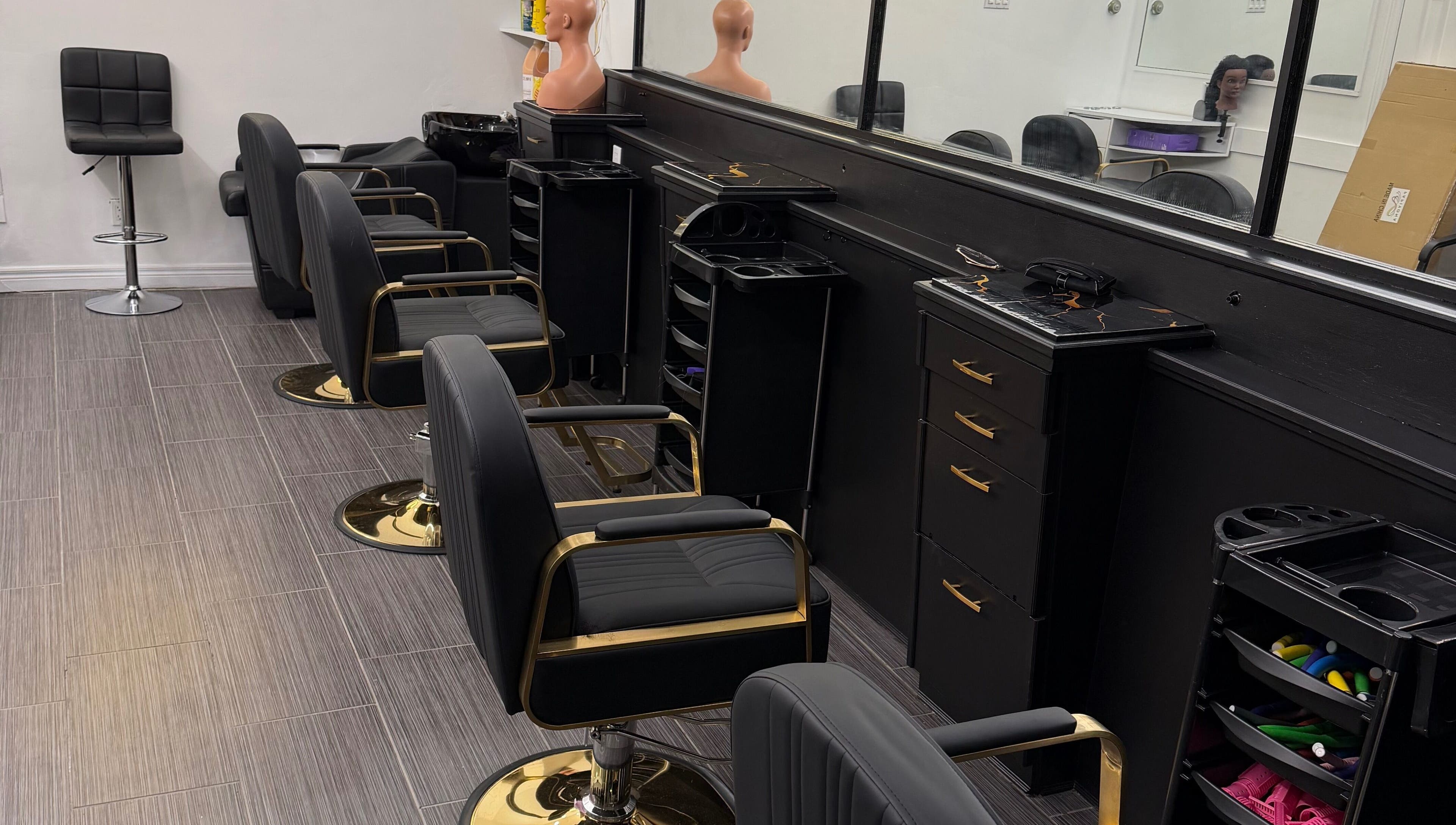 Modern styling chairs at Hair Affairs Braiding Parlor, Toronto, Ontario, CA, showcasing sleek design and comfort.