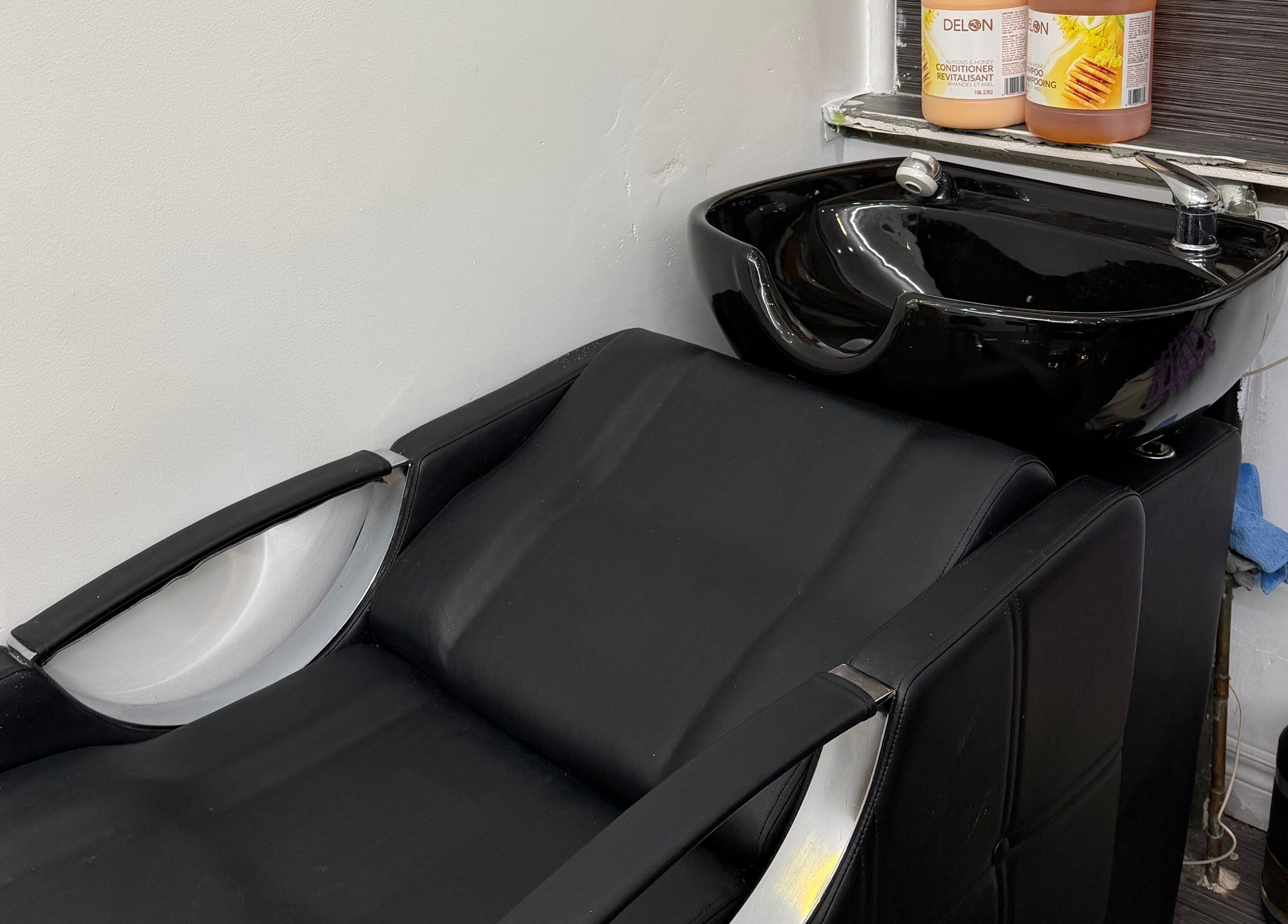 Modern hair wash station at Hair Affairs Braiding Parlor in Toronto, Ontario, CA featuring sleek black design.