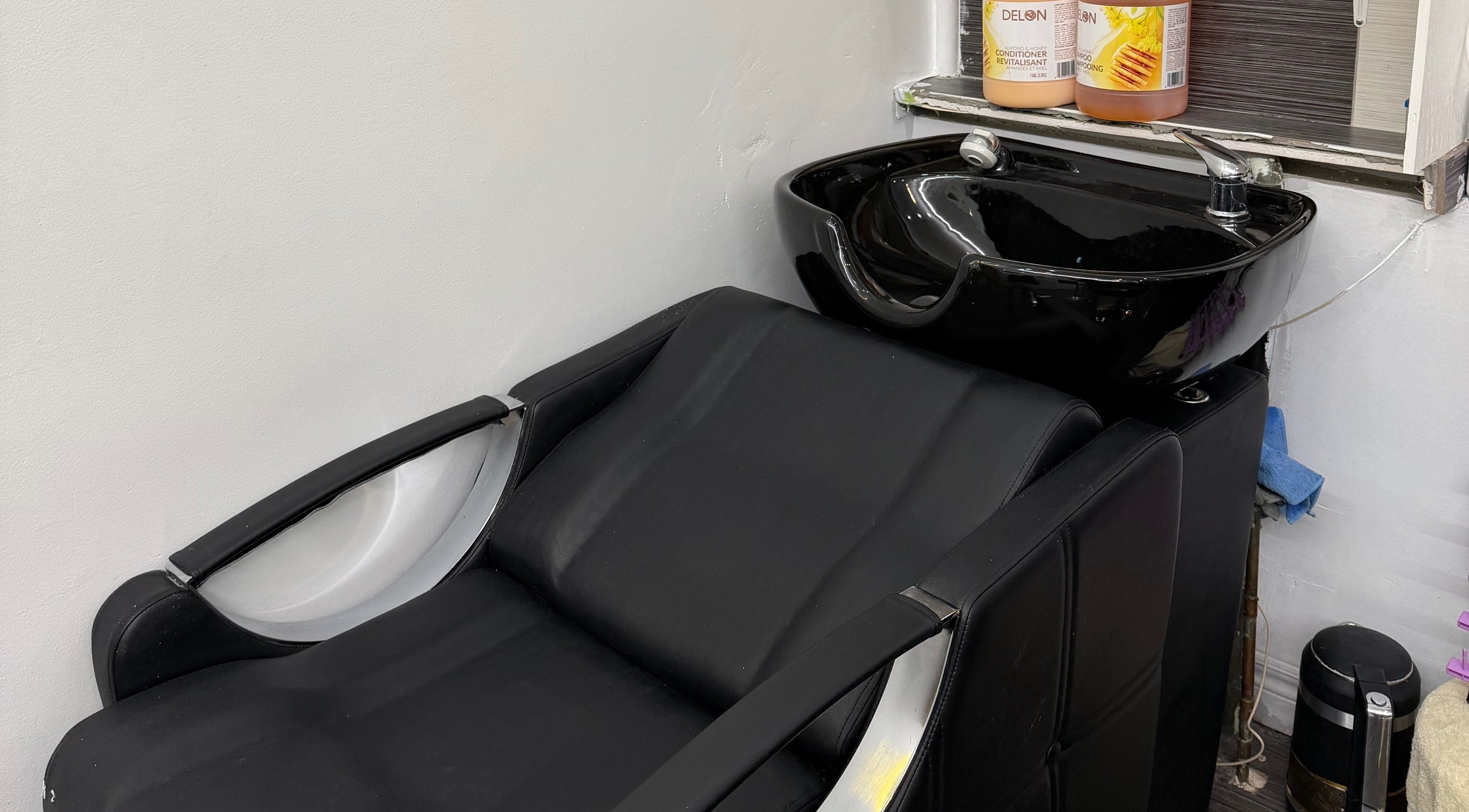 Modern hair wash station at Hair Affairs Braiding Parlor in Toronto, Ontario, CA featuring sleek black design.