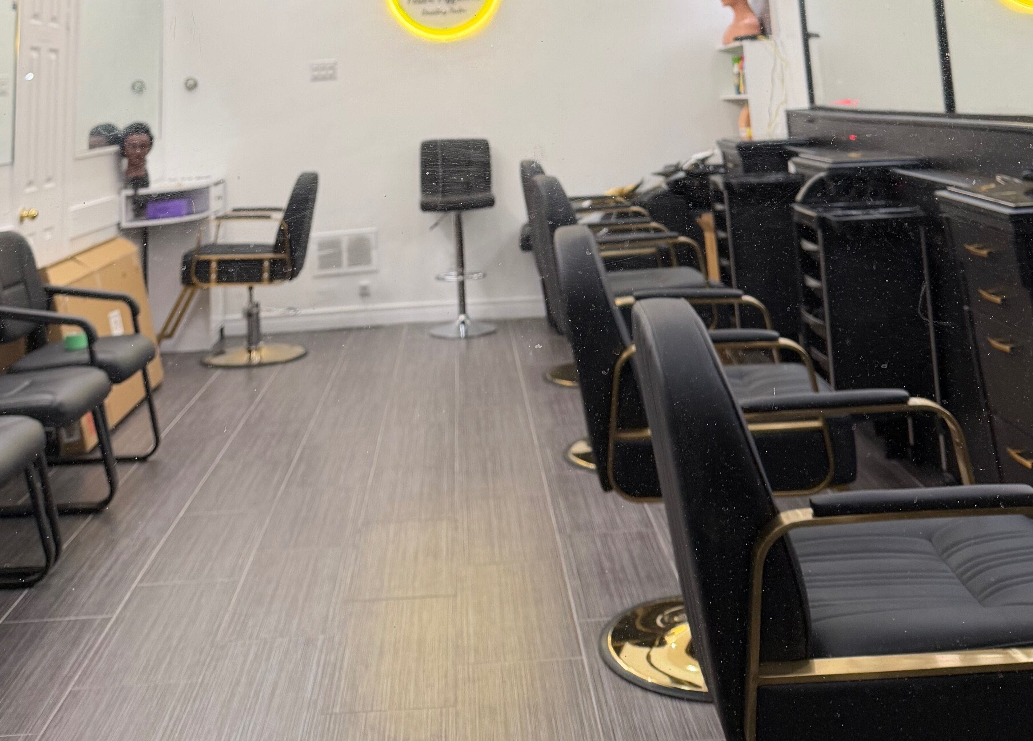 Modern salon chairs at Hair Affairs Braiding Parlor in Toronto, Ontario, CA, showcasing sleek interior design.