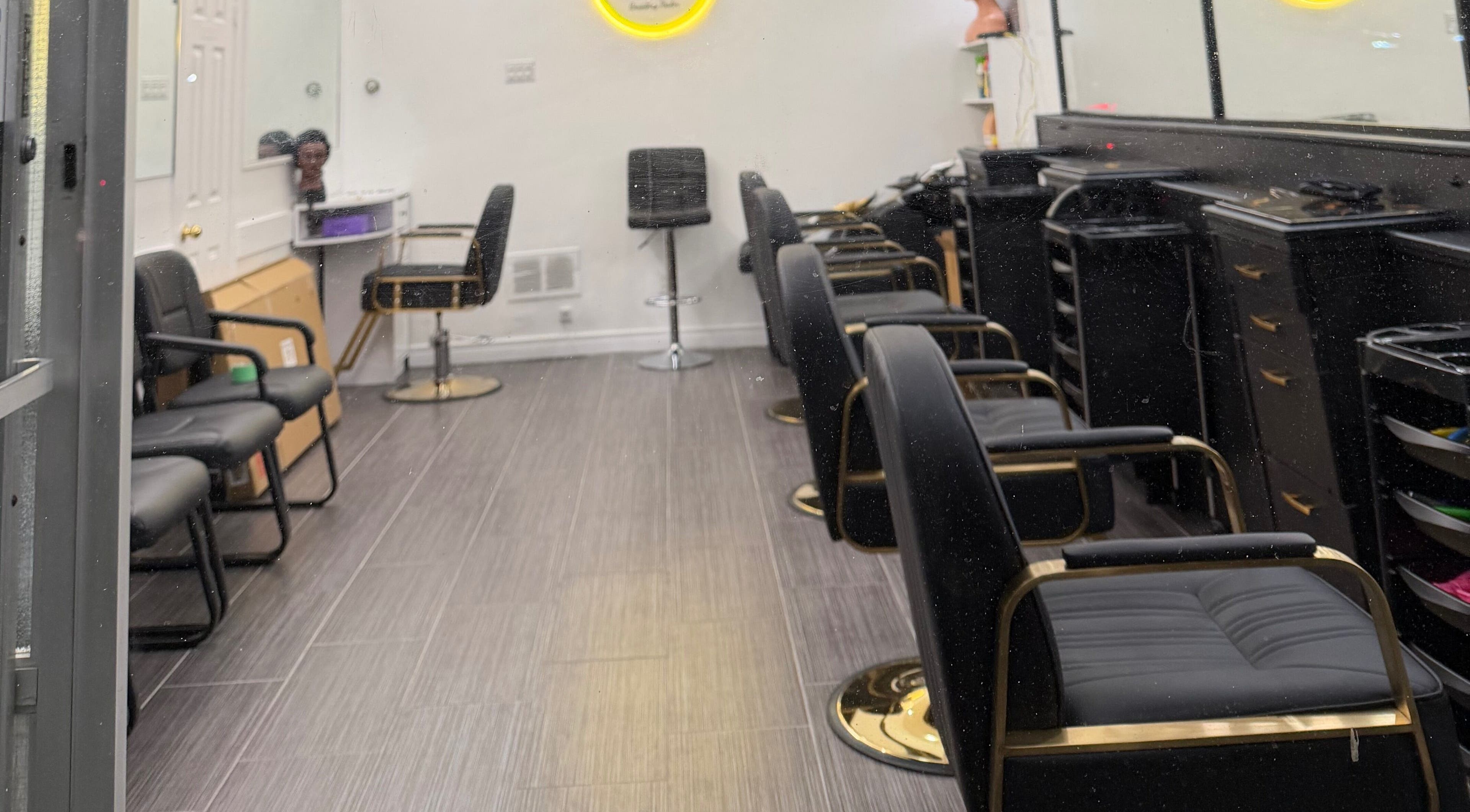 Modern salon chairs at Hair Affairs Braiding Parlor in Toronto, Ontario, CA, showcasing sleek interior design.