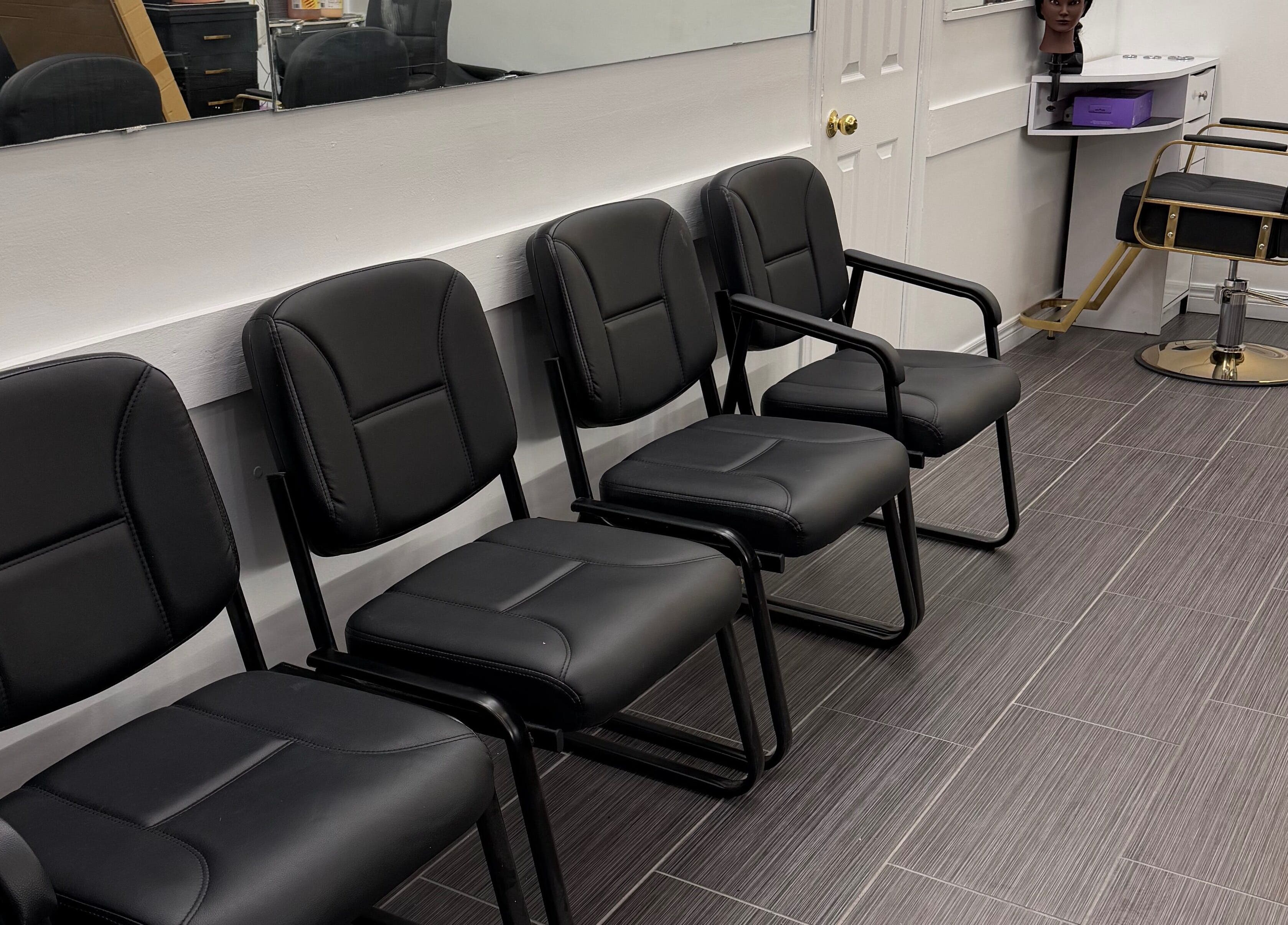 Sleek seating at Hair Affairs Braiding Parlor, Toronto, Ontario, CA offers comfort for clients.