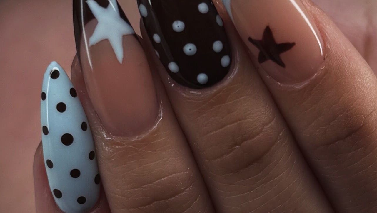 Stylish star and polka dot nail art at nailsby_agnes in Glendale, California, US.