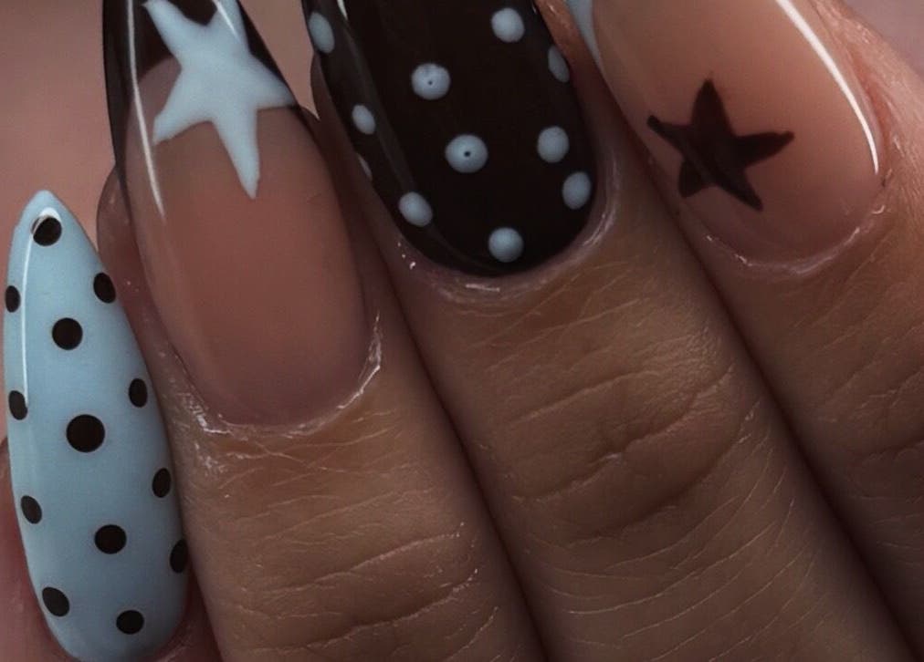 Stylish star and polka dot nail art at nailsby_agnes in Glendale, California, US.
