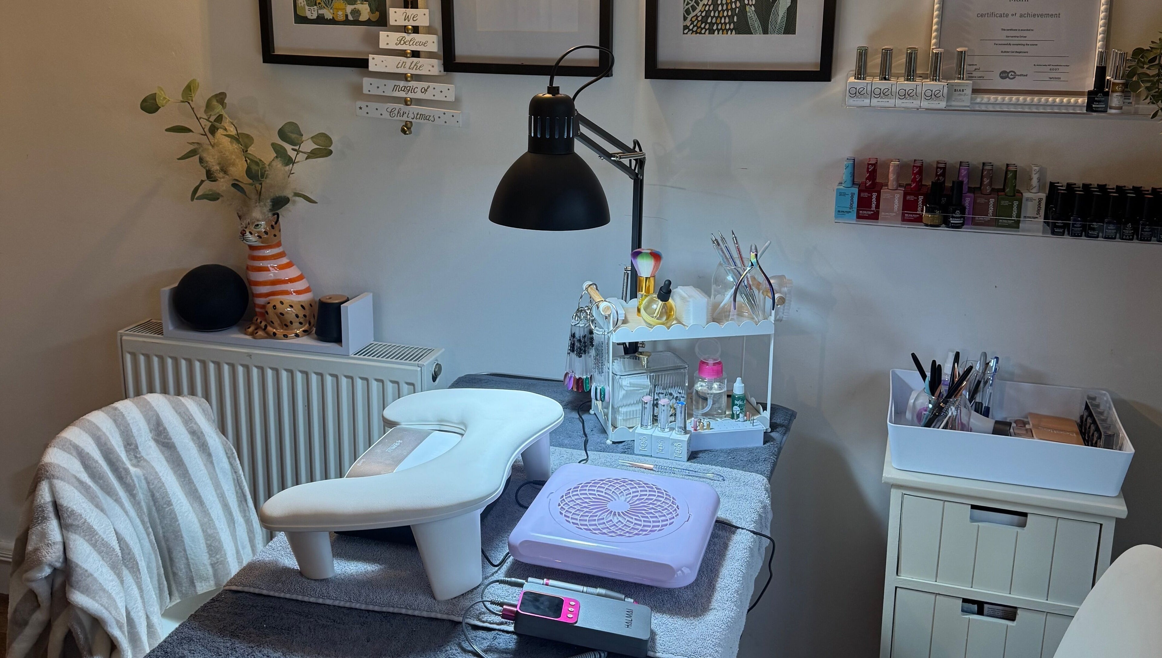 Chic nail station at BIAB beauty bar, Bradwell, England, GB, showcasing manicure tools and colorful nail polishes.
