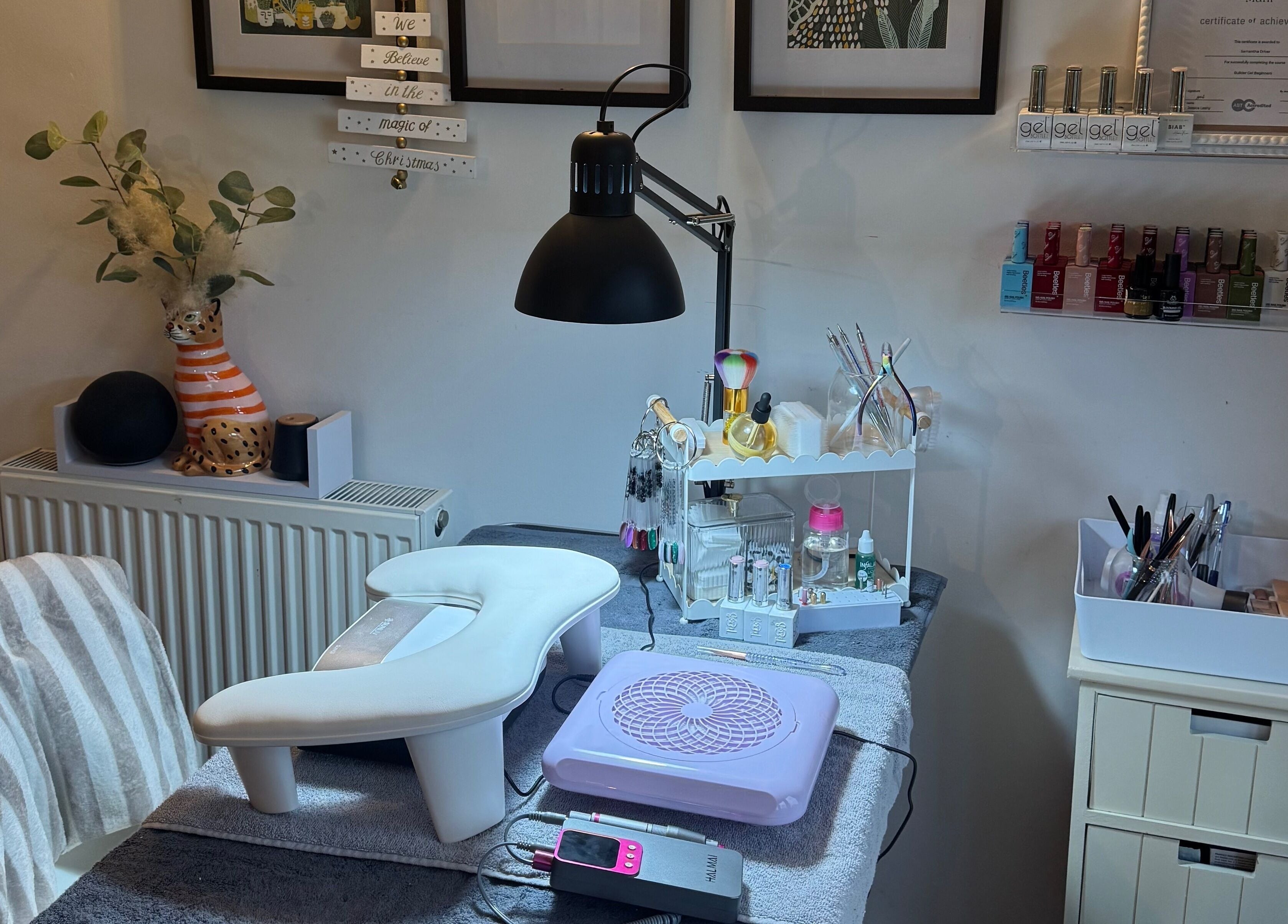 Chic nail station at BIAB beauty bar, Bradwell, England, GB, showcasing manicure tools and colorful nail polishes.