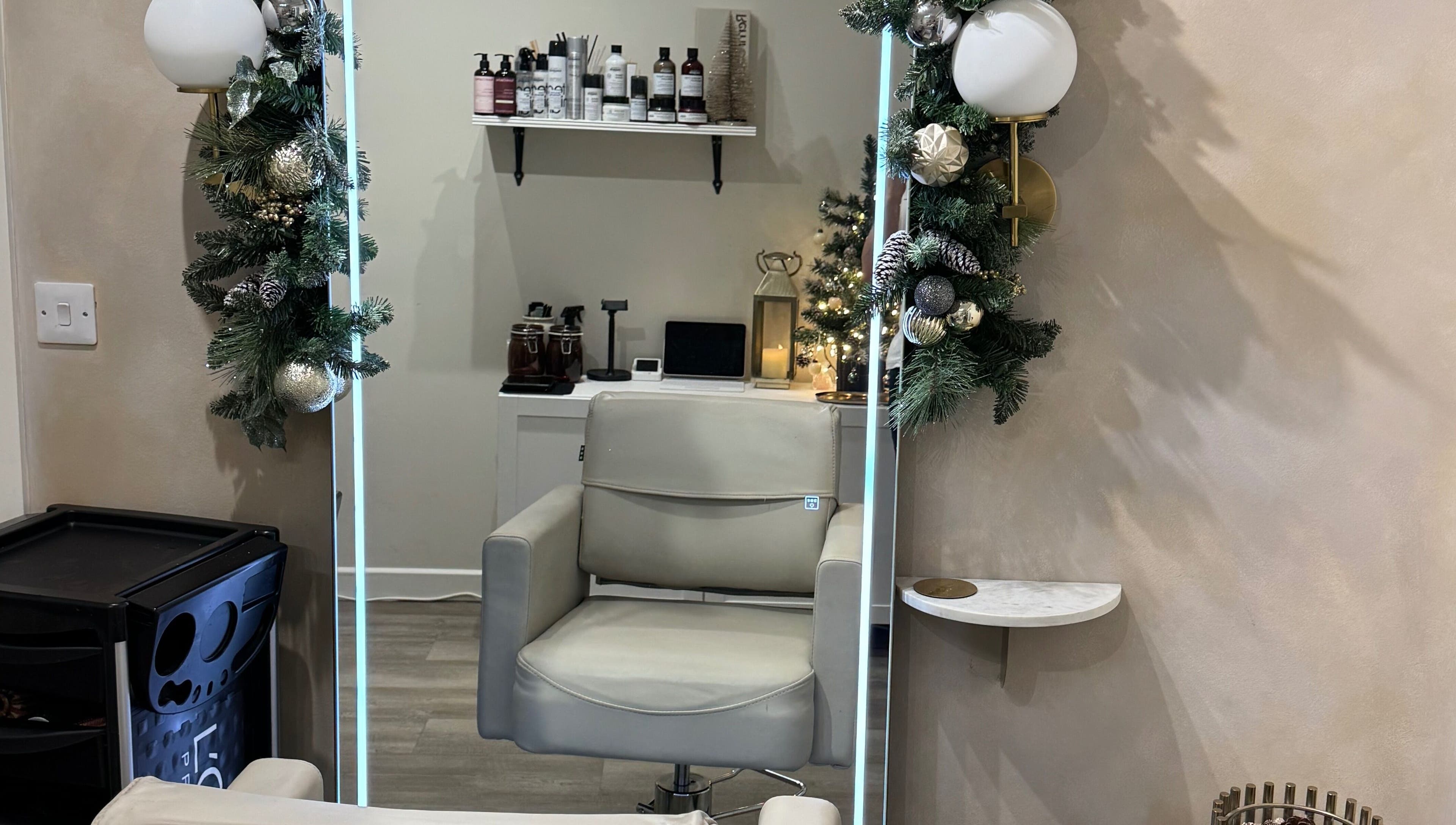 Modern salon chair at Aidan Steele Hair, Warwick, England, GB, adorned with festive decor.