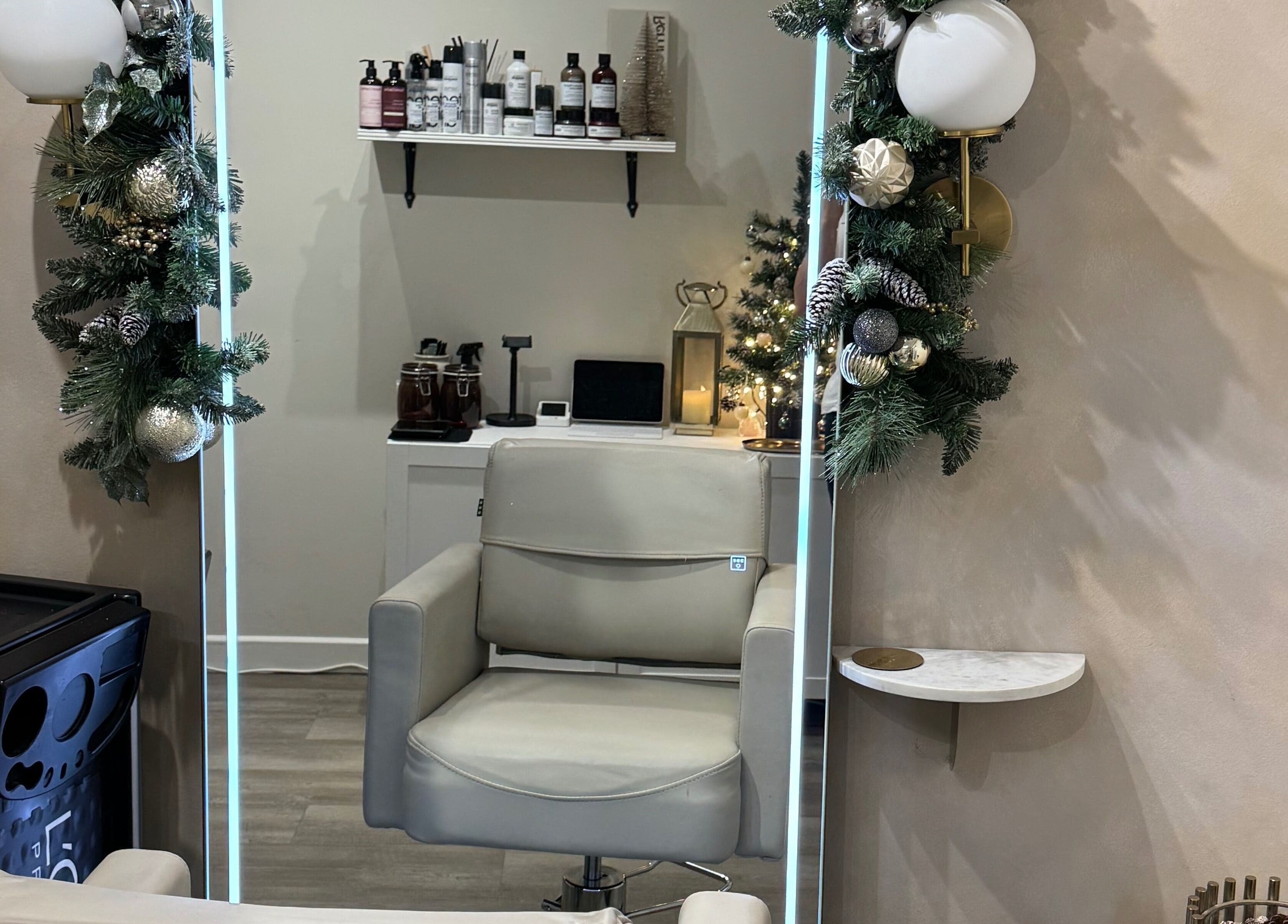 Modern salon chair at Aidan Steele Hair, Warwick, England, GB, adorned with festive decor.