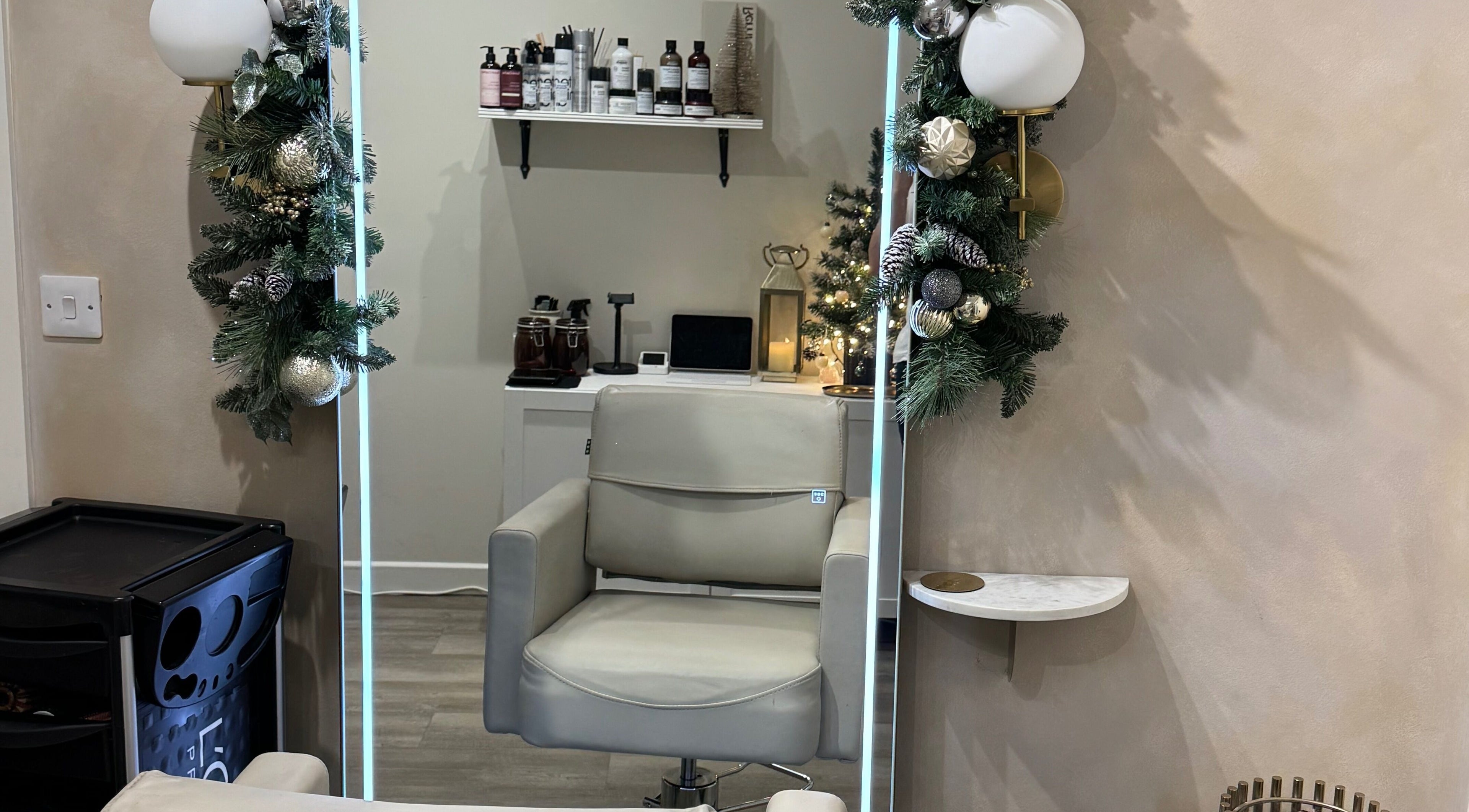 Modern salon chair at Aidan Steele Hair, Warwick, England, GB, adorned with festive decor.