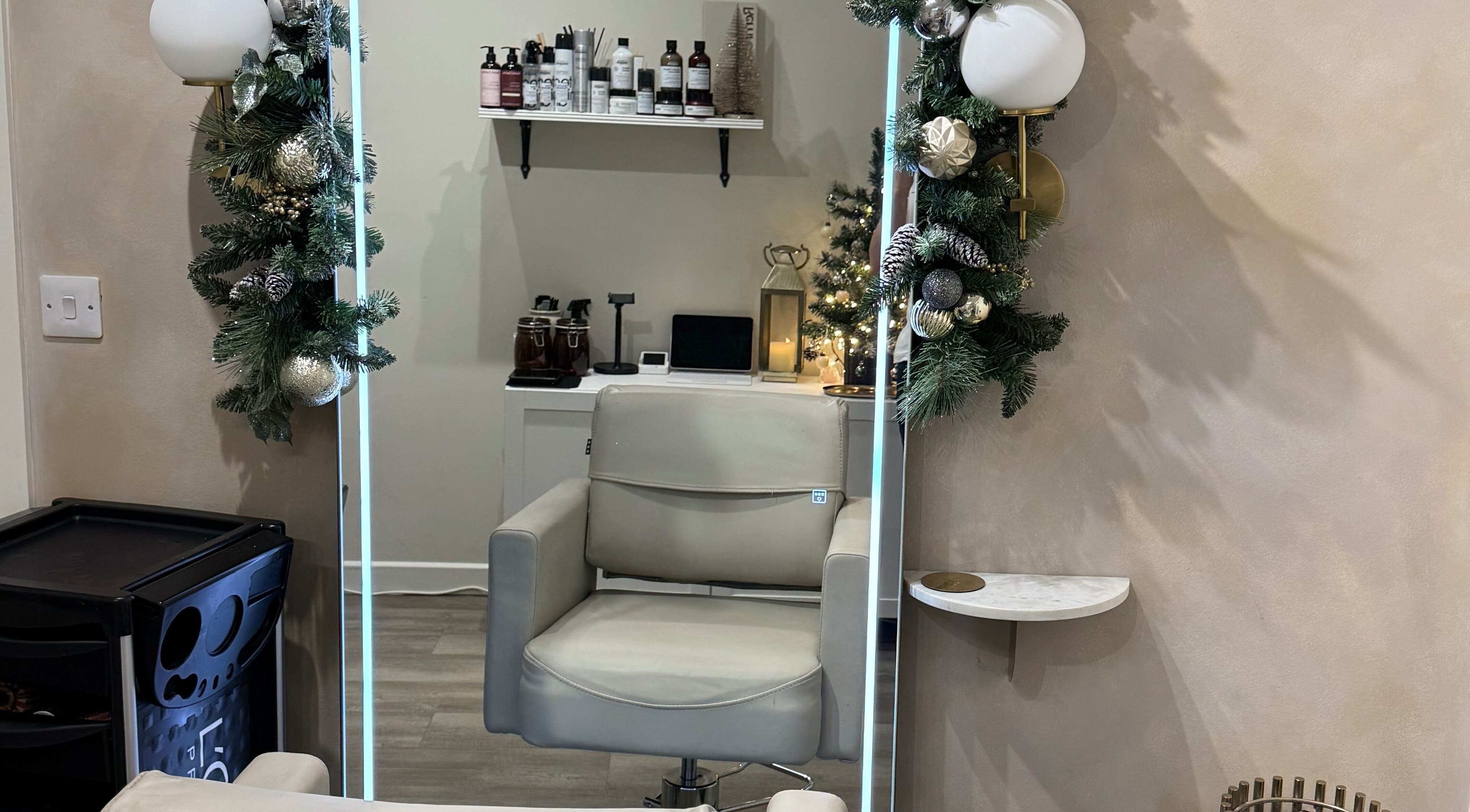 Elegant hair salon chair at Aidan Steele Hair, Warwick, England, GB, adorned with festive decor.