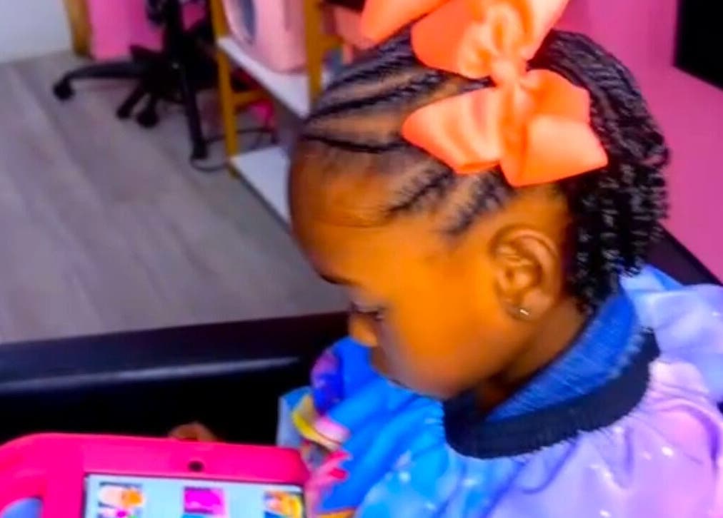 Child with braided hair and orange bow at The Braiding Parlor, Nassau, New Providence, BS.