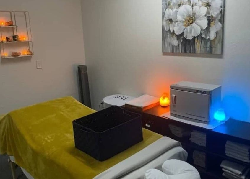 Tranquil spa room at Abbey Moonlight Spa in Oklahoma City, Oklahoma, US with warm lighting and massage table.