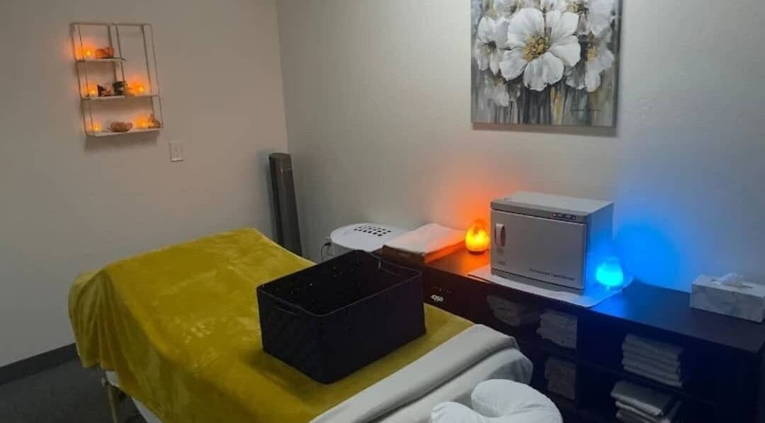 Tranquil spa room at Abbey Moonlight Spa in Oklahoma City, Oklahoma, US with warm lighting and massage table.