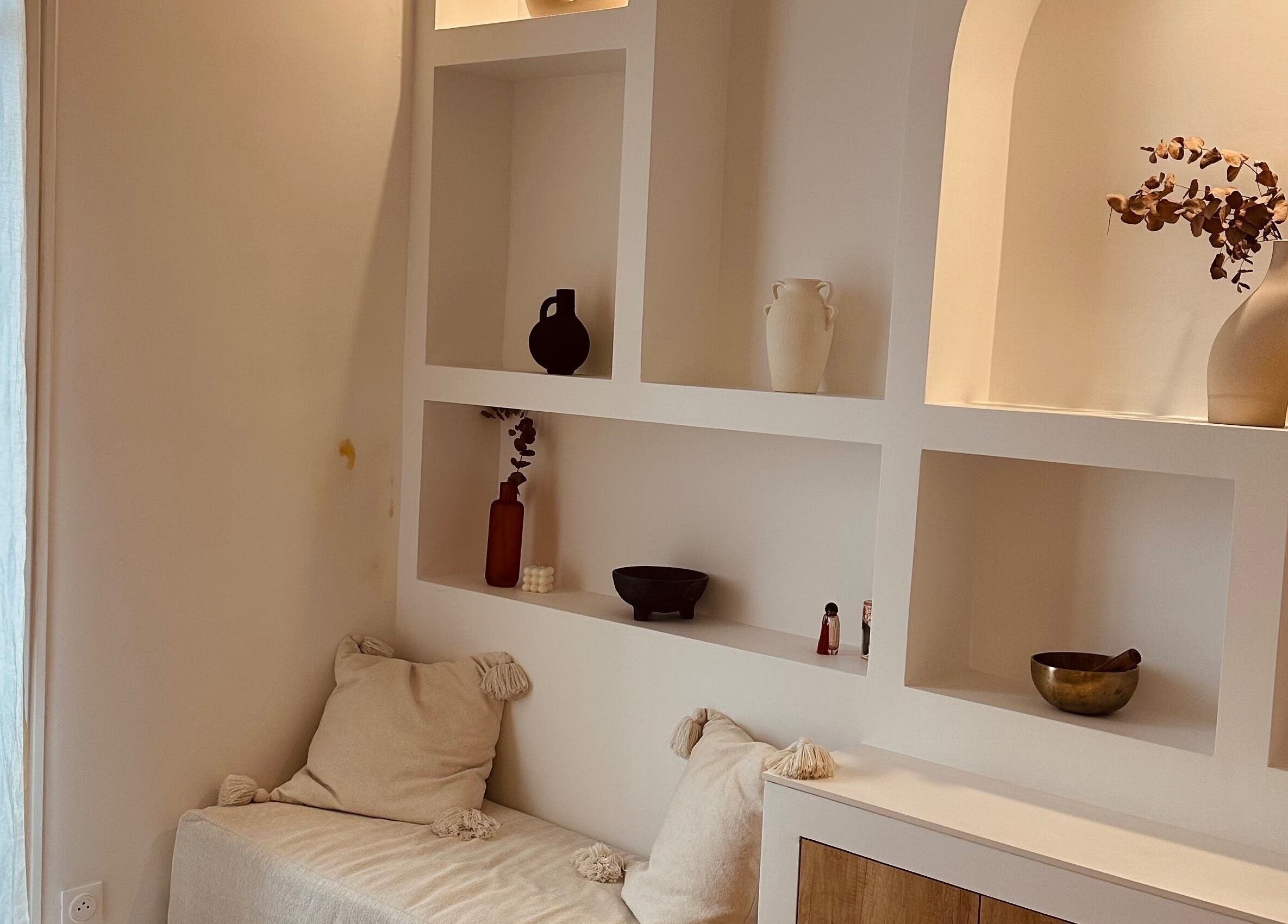 Minimalist decor at Perle Cabre, Nice, Provence-alpes-côte D'azur, FR with modern shelving and cozy seating.
