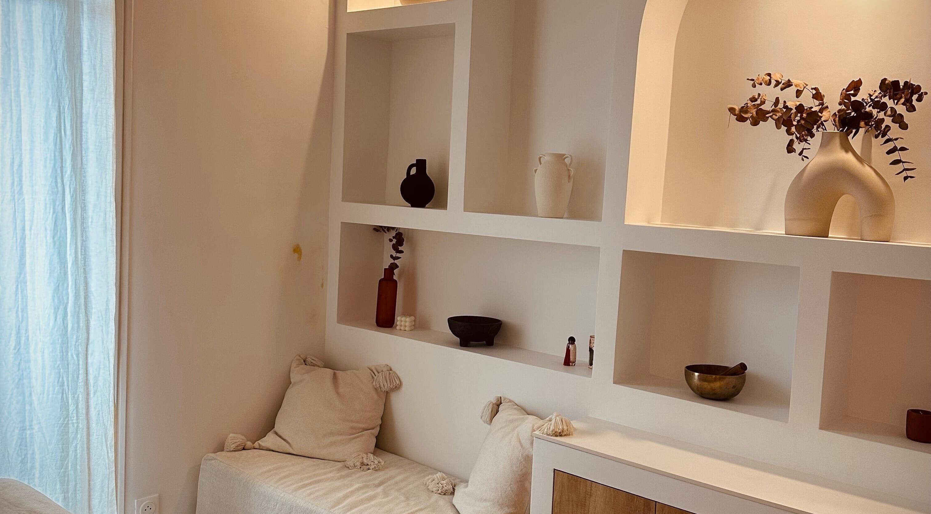 Minimalist decor at Perle Cabre, Nice, Provence-alpes-côte D'azur, FR with modern shelving and cozy seating.