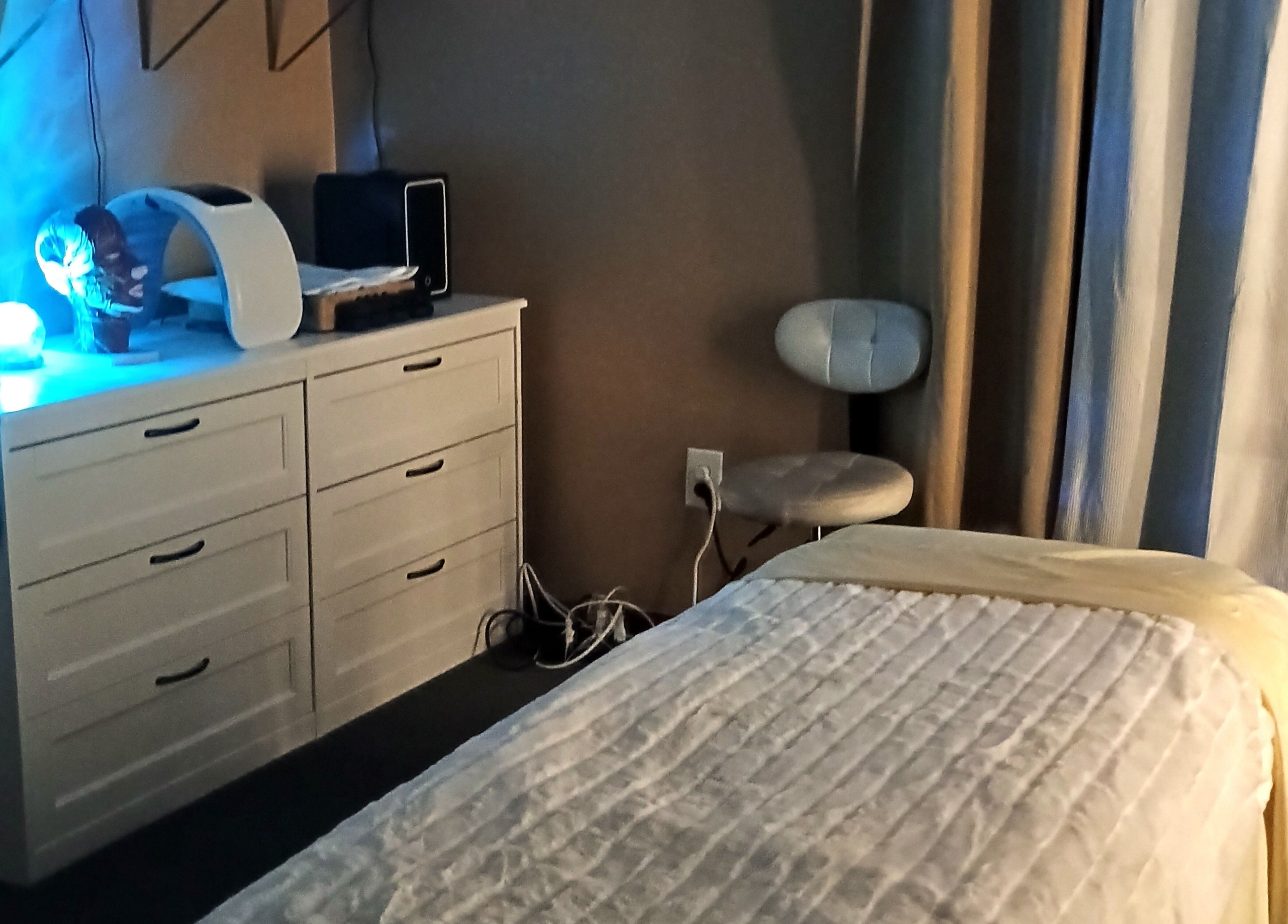 Cozy therapy room at Divine Flow Therapy, Gibbsboro, New Jersey, US, featuring a massage table and calming lighting.