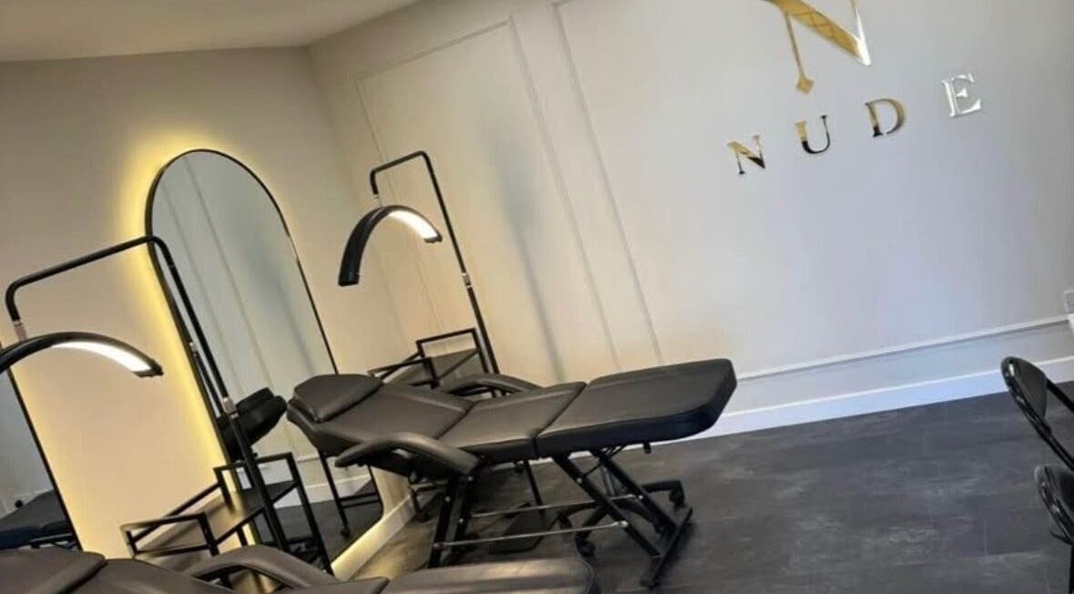 Modern treatment chairs at The Nude Method, Glasgow, Scotland, GB, with ambient lighting and stylish decor.