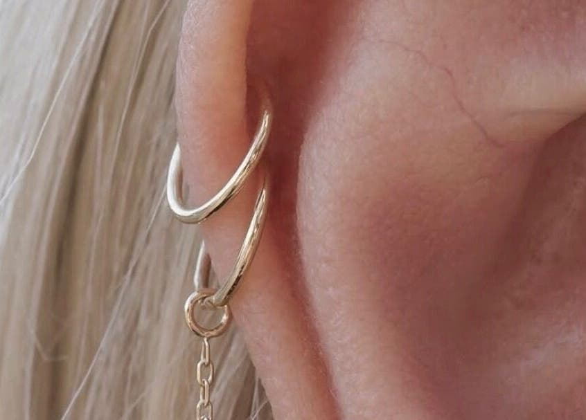 Elegant gold earrings showcased at The Nude Method, Glasgow, Scotland, GB. Perfect for a refined style.