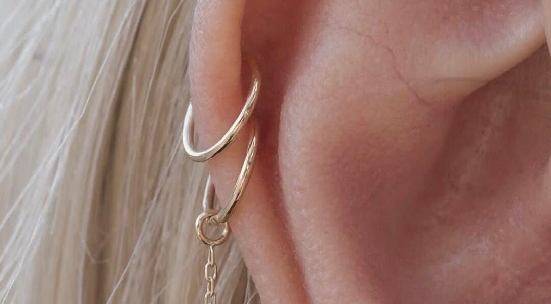 Elegant gold earrings showcased at The Nude Method, Glasgow, Scotland, GB. Perfect for a refined style.