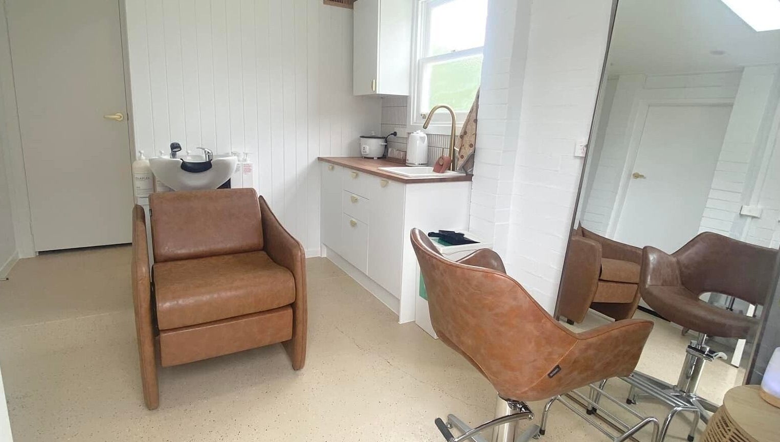 Elegant salon chair and mirror at Prosper Studio, Belmont, Victoria, AU featuring modern decor.